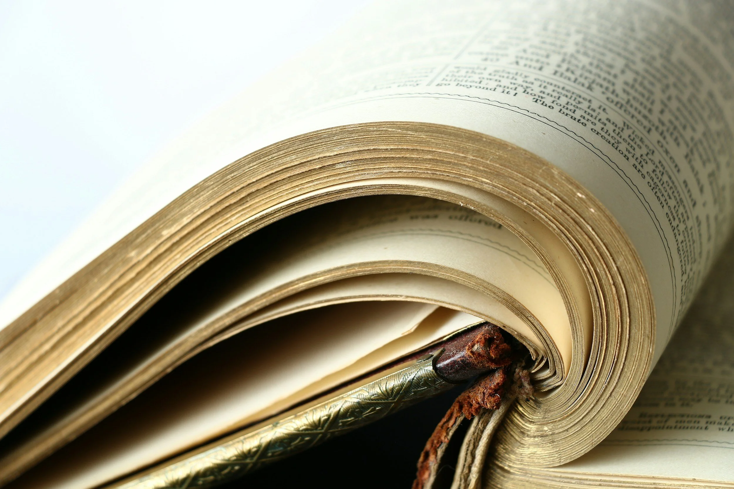 Open vintage book with aged pages and a decorative bookmark