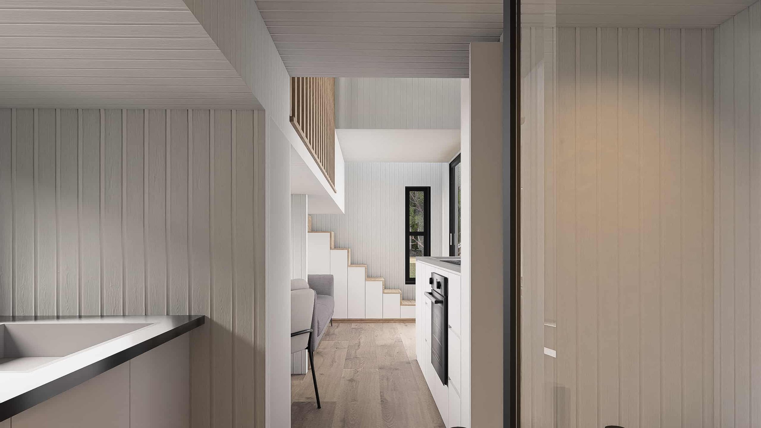 Interior view of a modern minimalist home with white walls, wooden flooring, a staircase, and a kitchen area with a black oven.