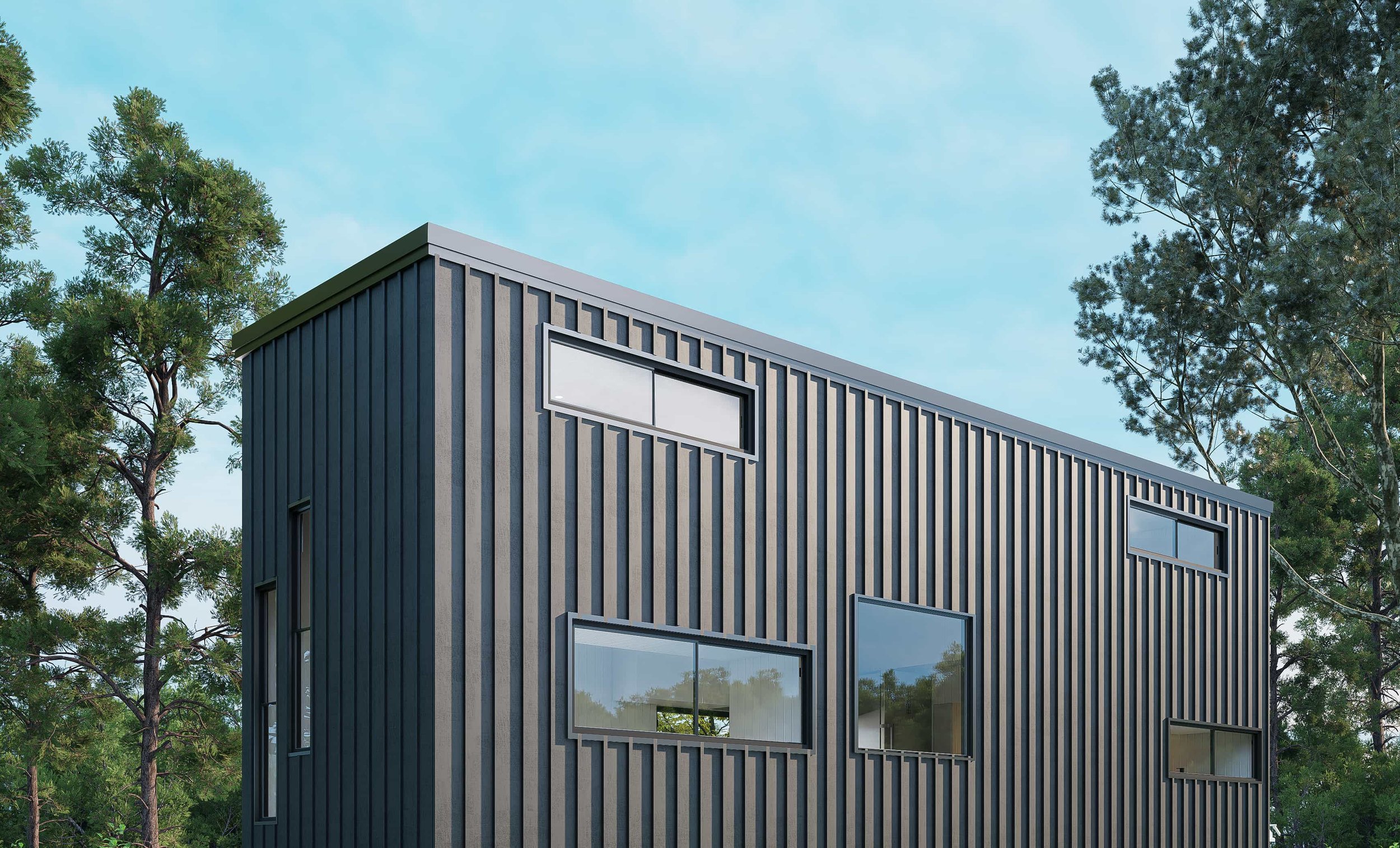Modern dark gray house with vertical siding, multiple rectangular windows, surrounded by tall trees and a cloudy sky.