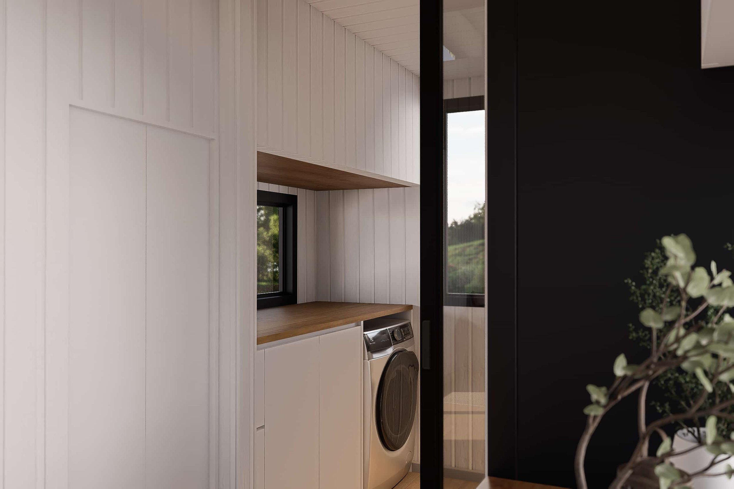 Laundry room with white wood-paneled walls, a wooden shelf, a small window, a washing machine, black-framed glass door, and greenery outside.
