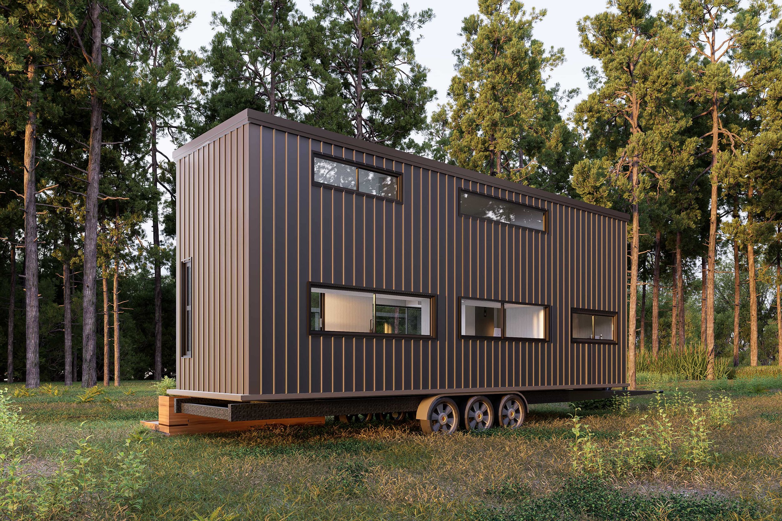 Modern tiny house with black and gray vertical siding on wheels in a wooded area.