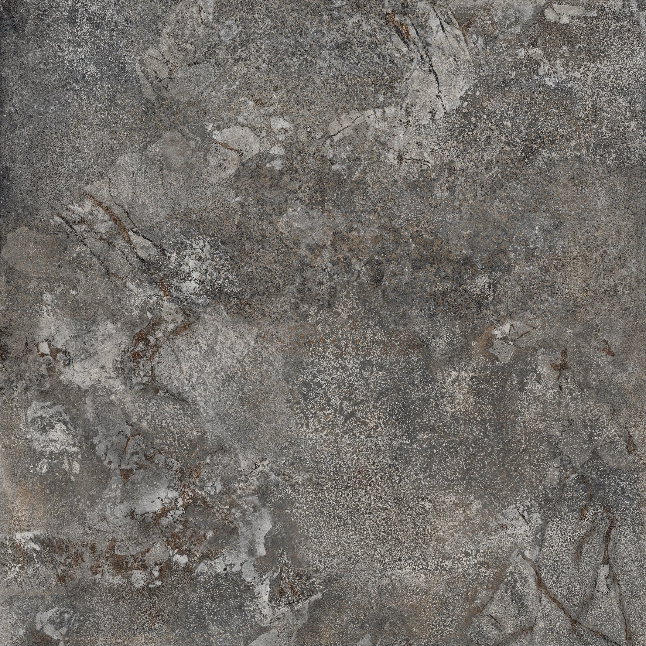 A close-up view of a textured stone or concrete surface with various cracks, patterns, and color variations in gray and brown tones.