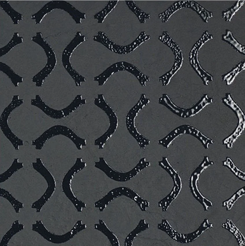 Black and white patterned paper or fabric with crescent and line designs.