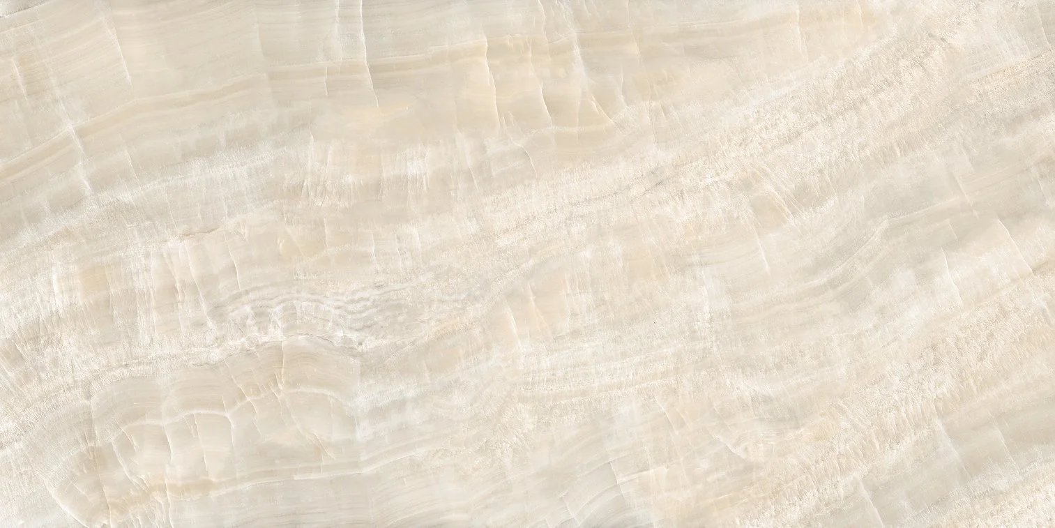 Close-up view of a light-colored stone or marble surface with natural veining and texture.