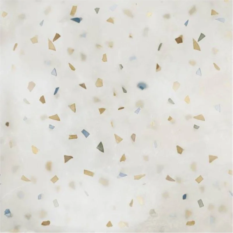 Confetti scattered on a white surface, with pieces of different shapes and colors, including gold, silver, and blue.