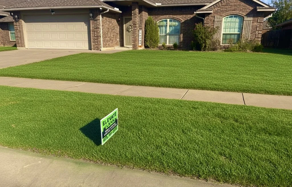 A front yard with well-maintained green grass, sidewalk, and a house with a brick exterior. There is a small green sign that says 'Elevate La Grange' near the sidewalk.