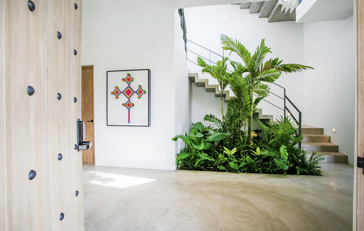 Main entrance with atrium and indoor palm 