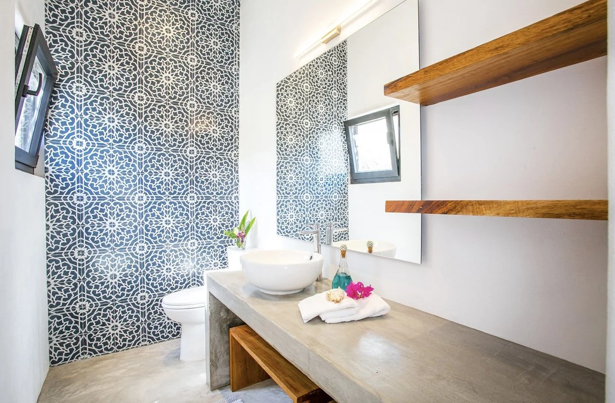 bathroom with a wall of bright blue tiles
