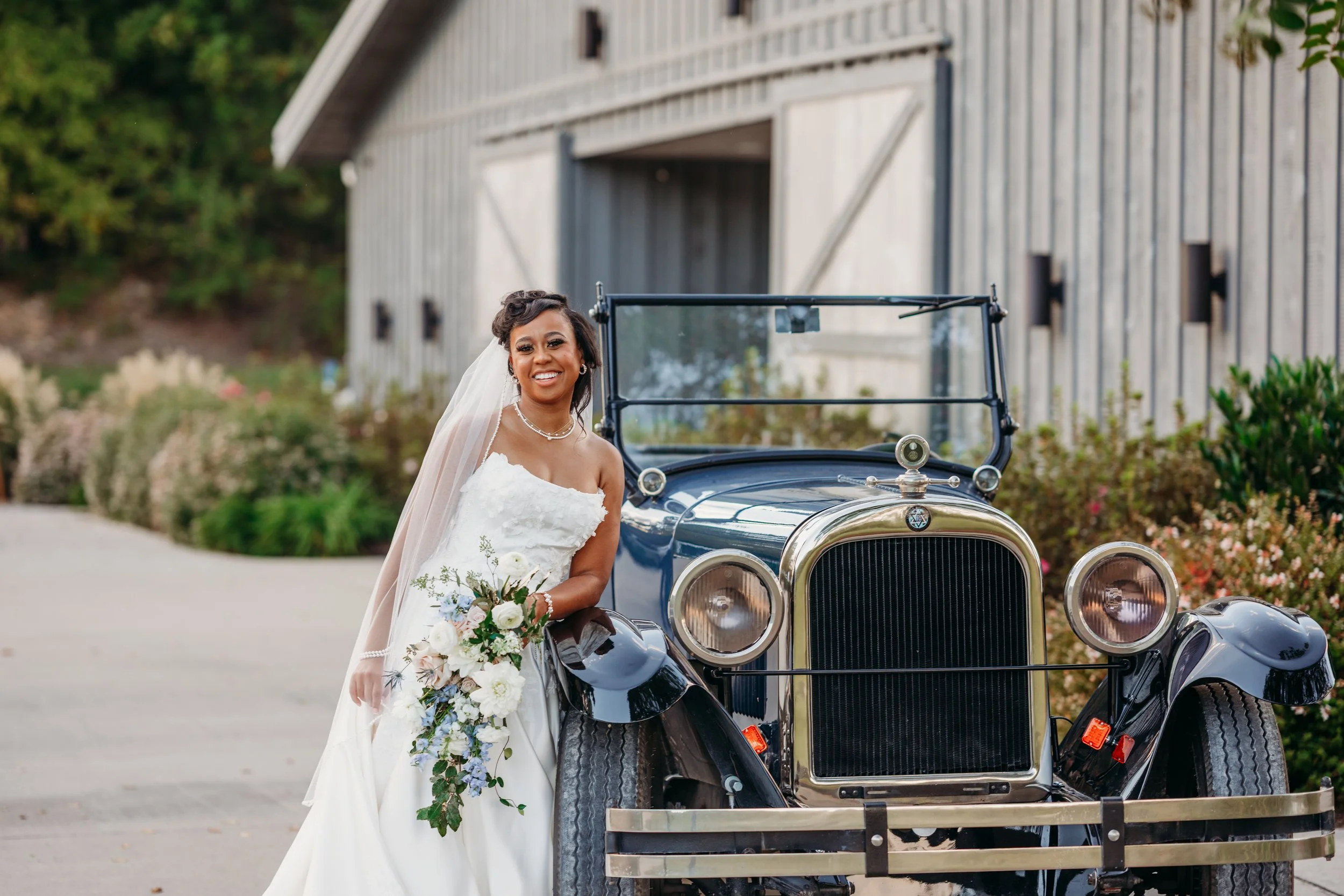 Chattanooga wedding florist blue white blush delphinium dahlia black bride summer florals garden style howe farms apple barn black bride bridal bouquet vintage car