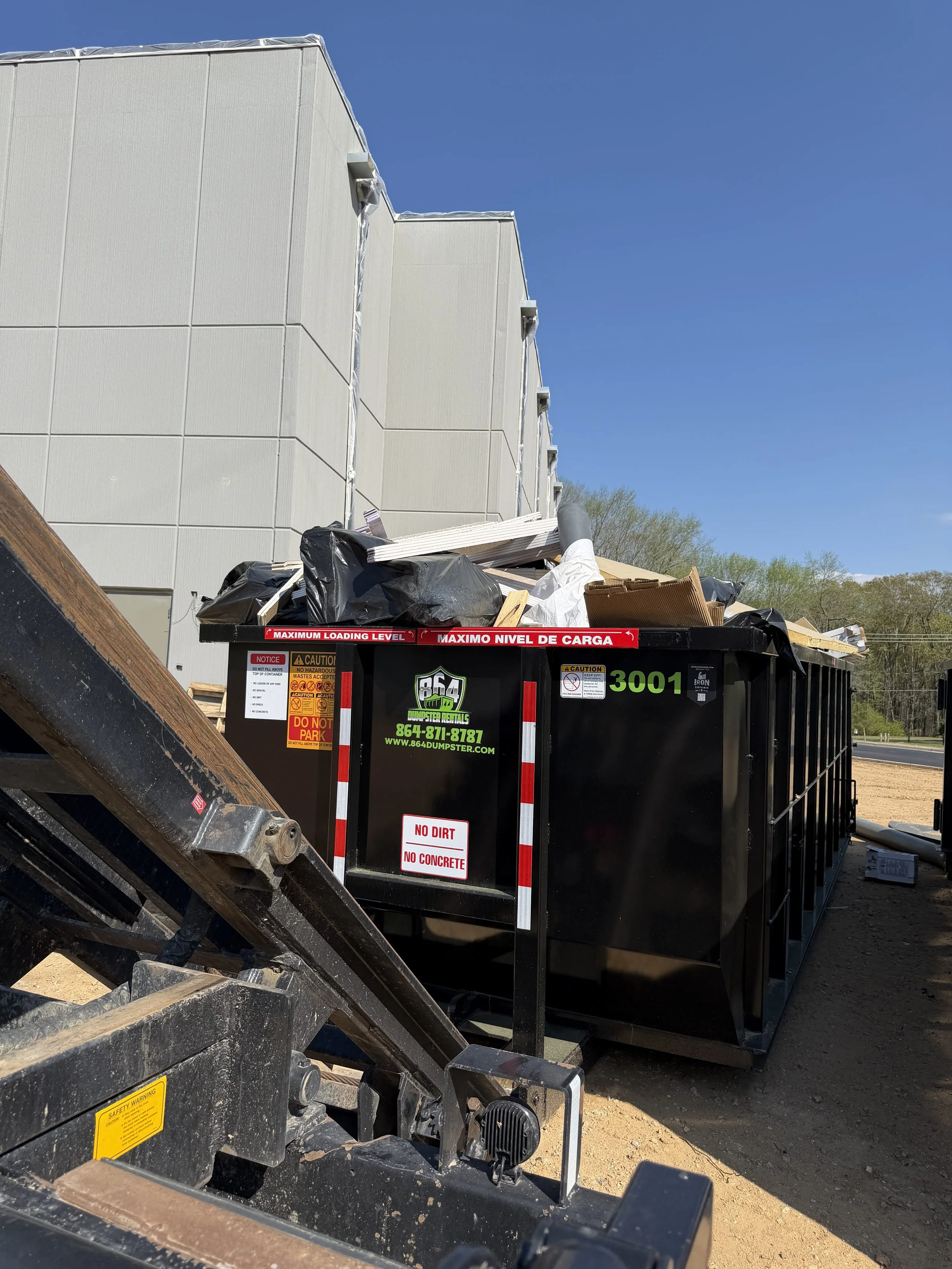 open top dumpster with commercial construction waste
