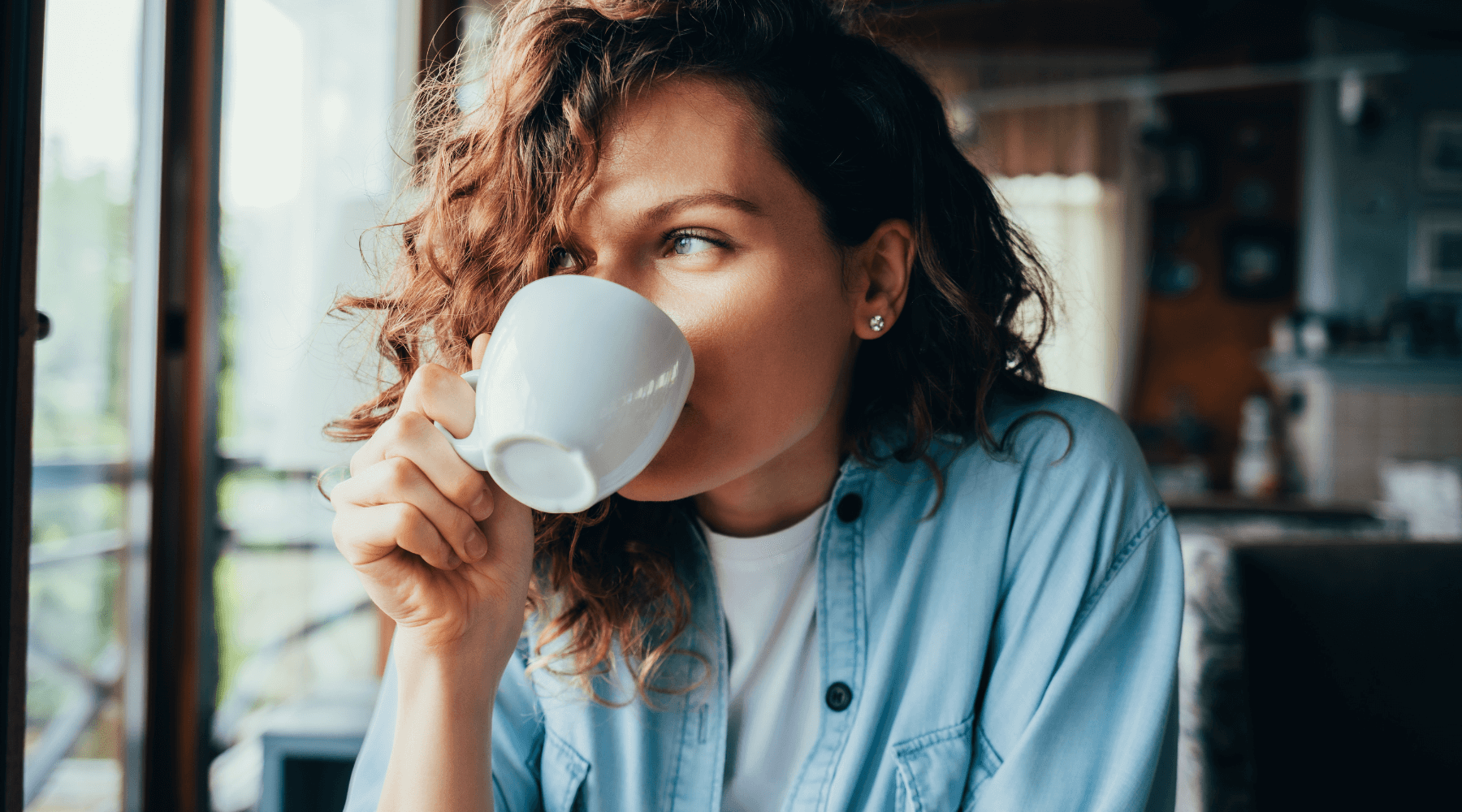 an image of a mom drinking a cup of coffee, demonstrating the importance of stay at home moms to have morning routine set in place to allow peaceful mornings