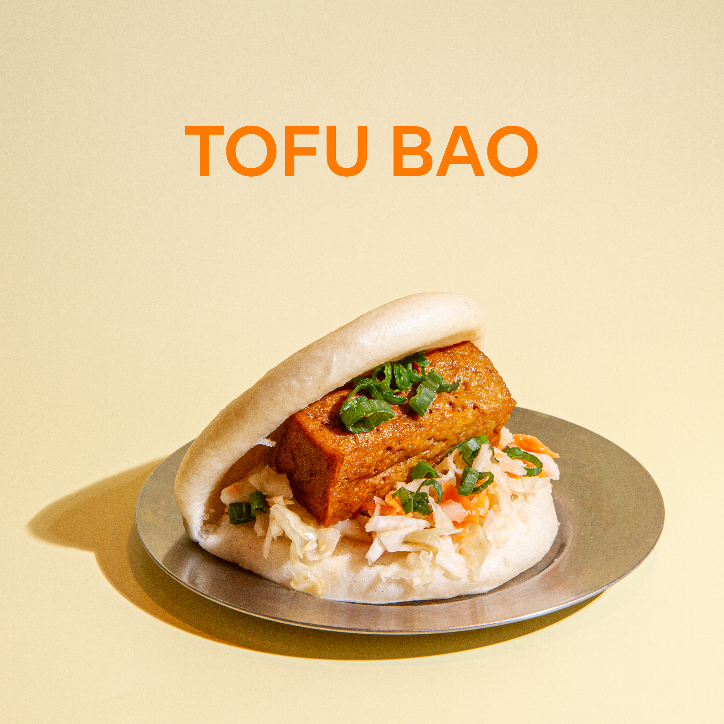 Hand-rolled steamed bun, filled with braised tofu and Taiwanese pickles.