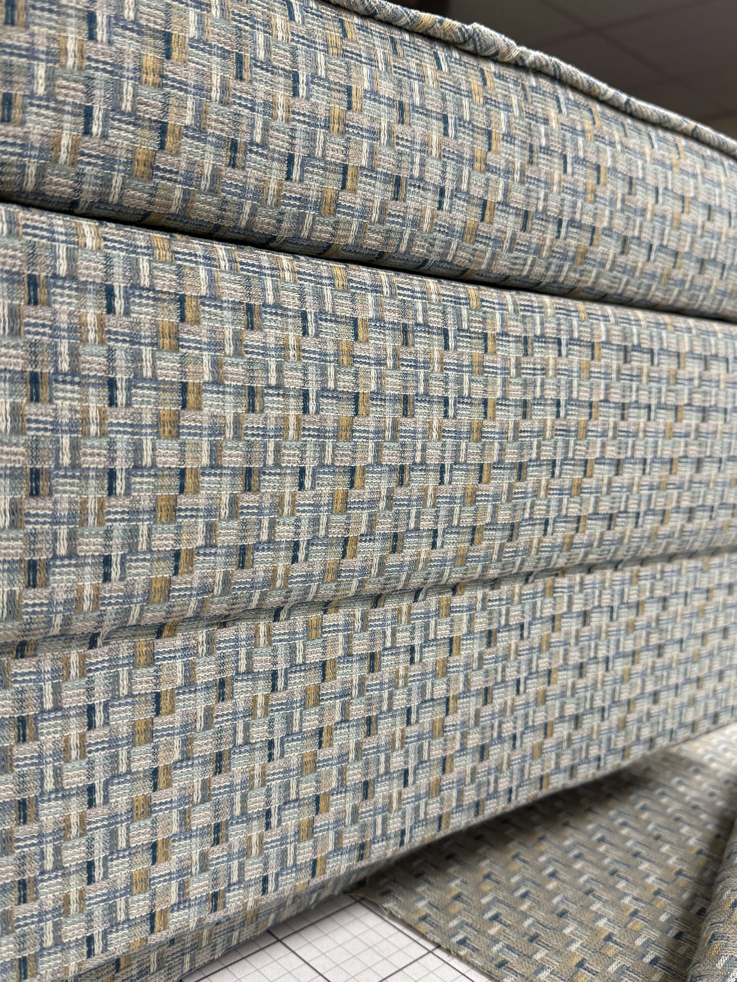 Close-up of a patterned fabric upholstery on a piece of furniture