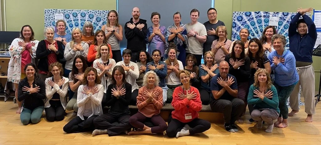 Group of participants at an IFS retreat gathered together in a shared moment of connection and reflection