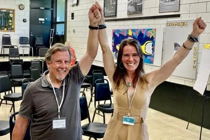 Laura Schmidt with Richard Schwartz, founder of IFS, celebrating together at a training event