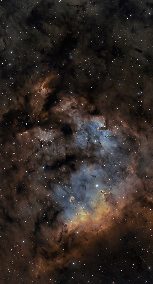 A deep space photo of a colorful nebula with stars scattered throughout.