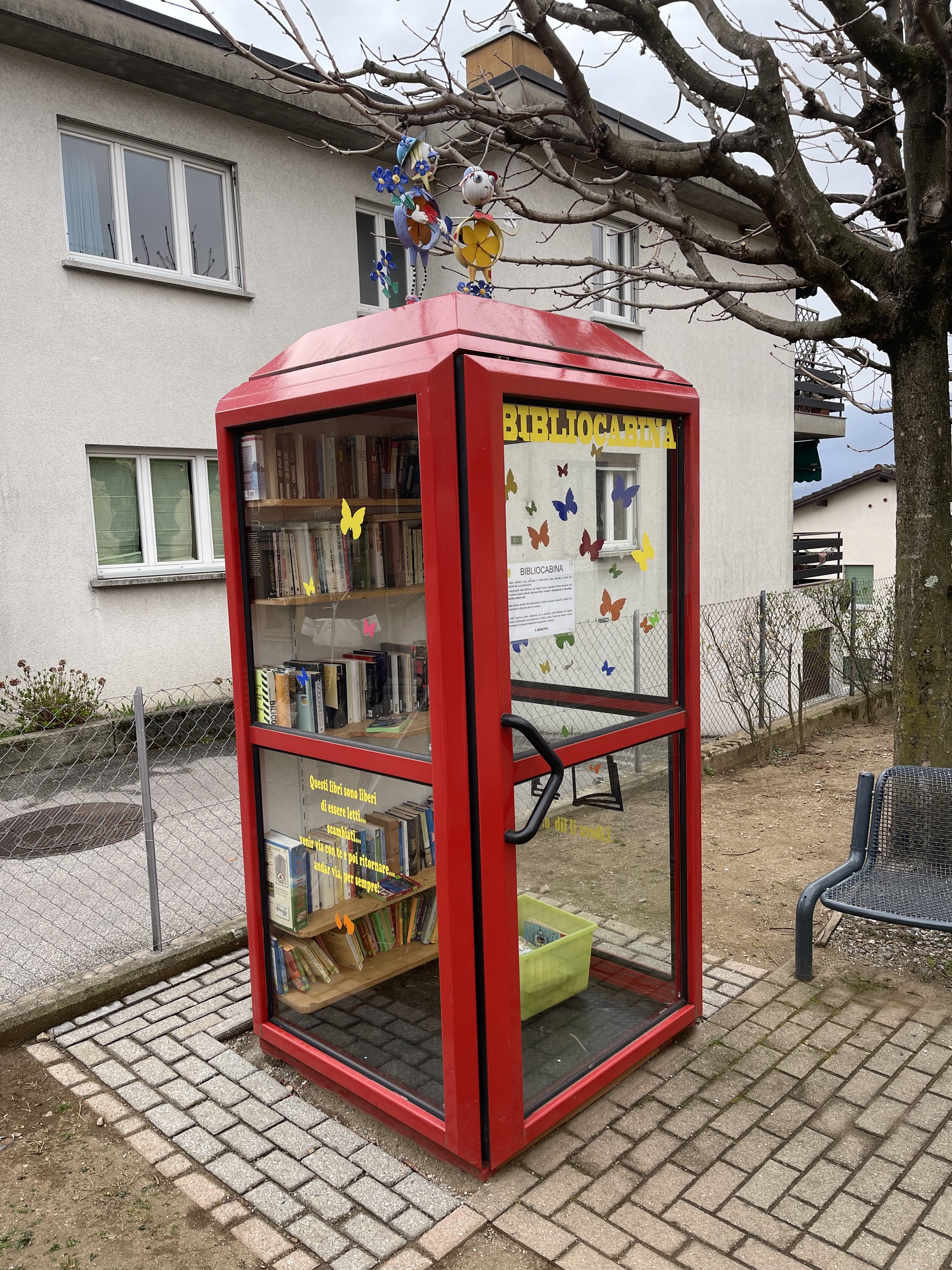 An old British styled phone booth that is now a book exchange library