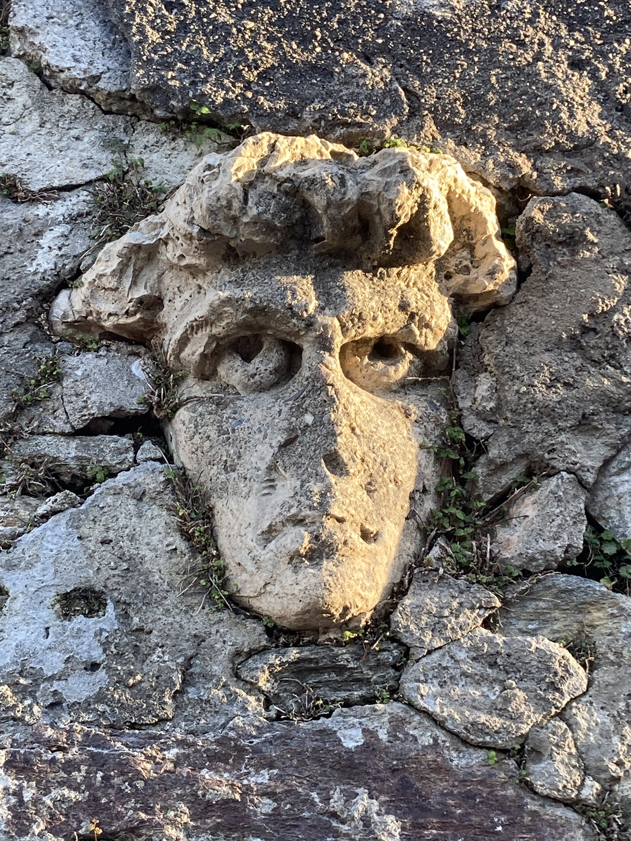 This stone head was embedded in the wall next to Church of Porza.