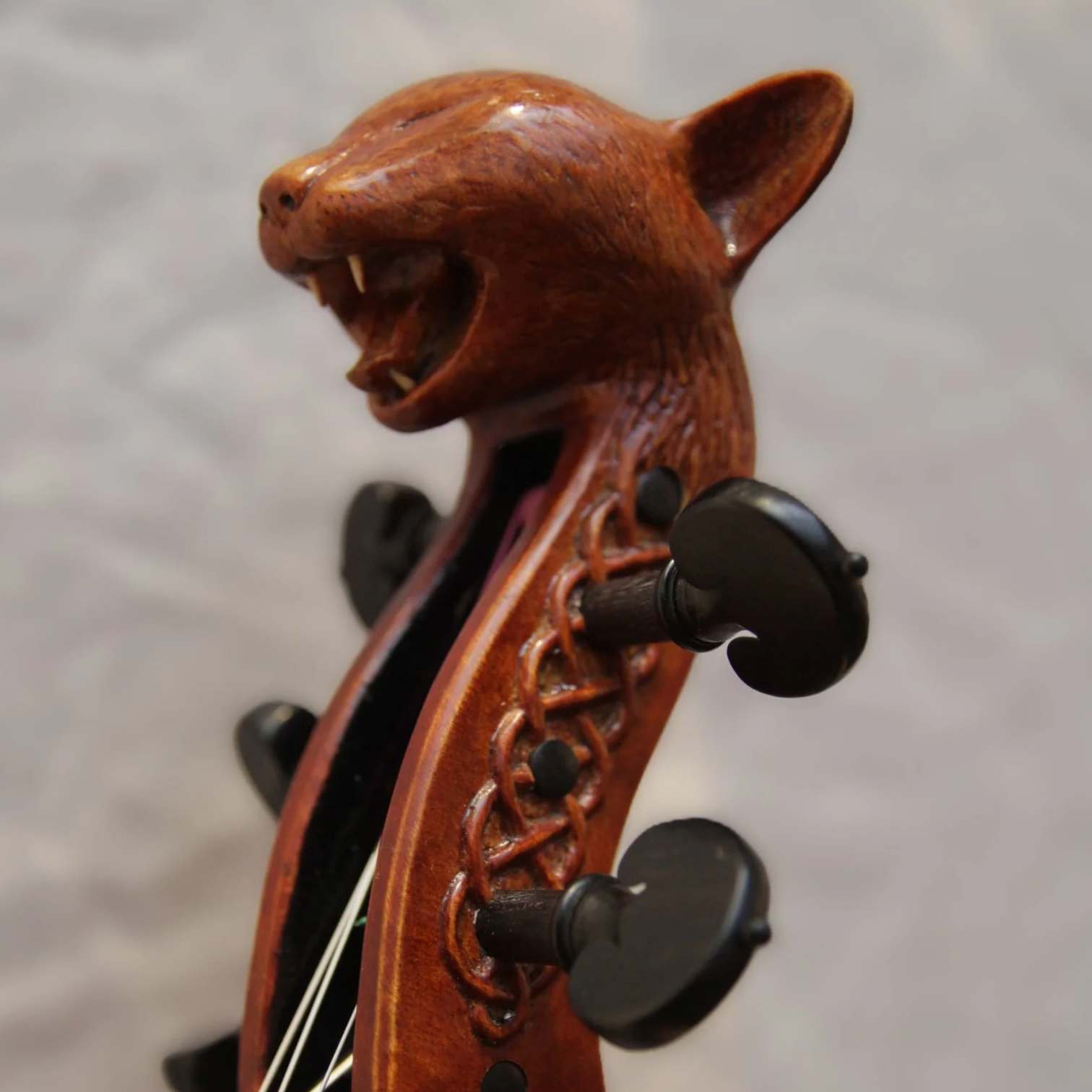 carved cat head on top of 5-string viola