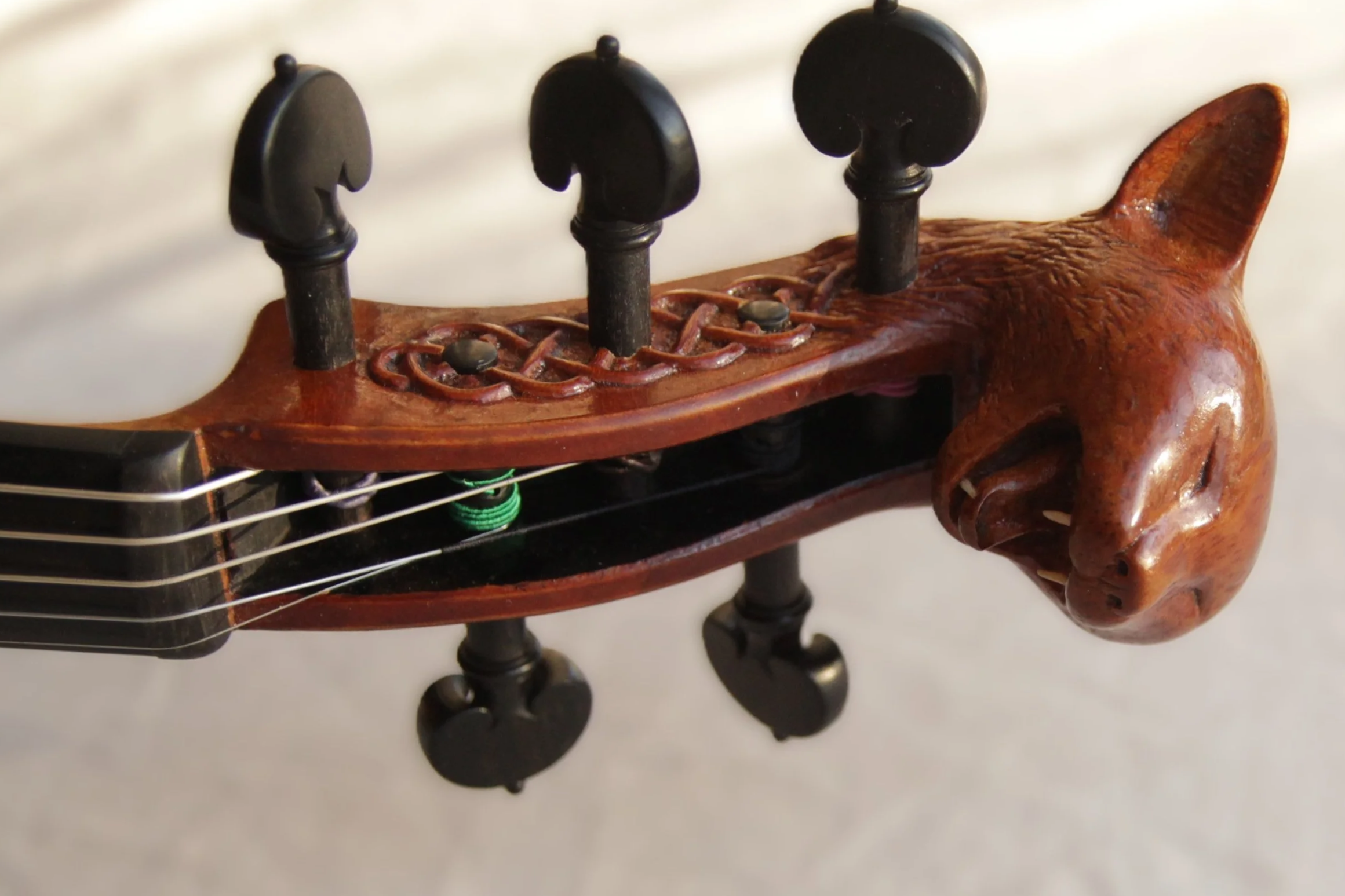 carved cat head and decoration on viola scroll 