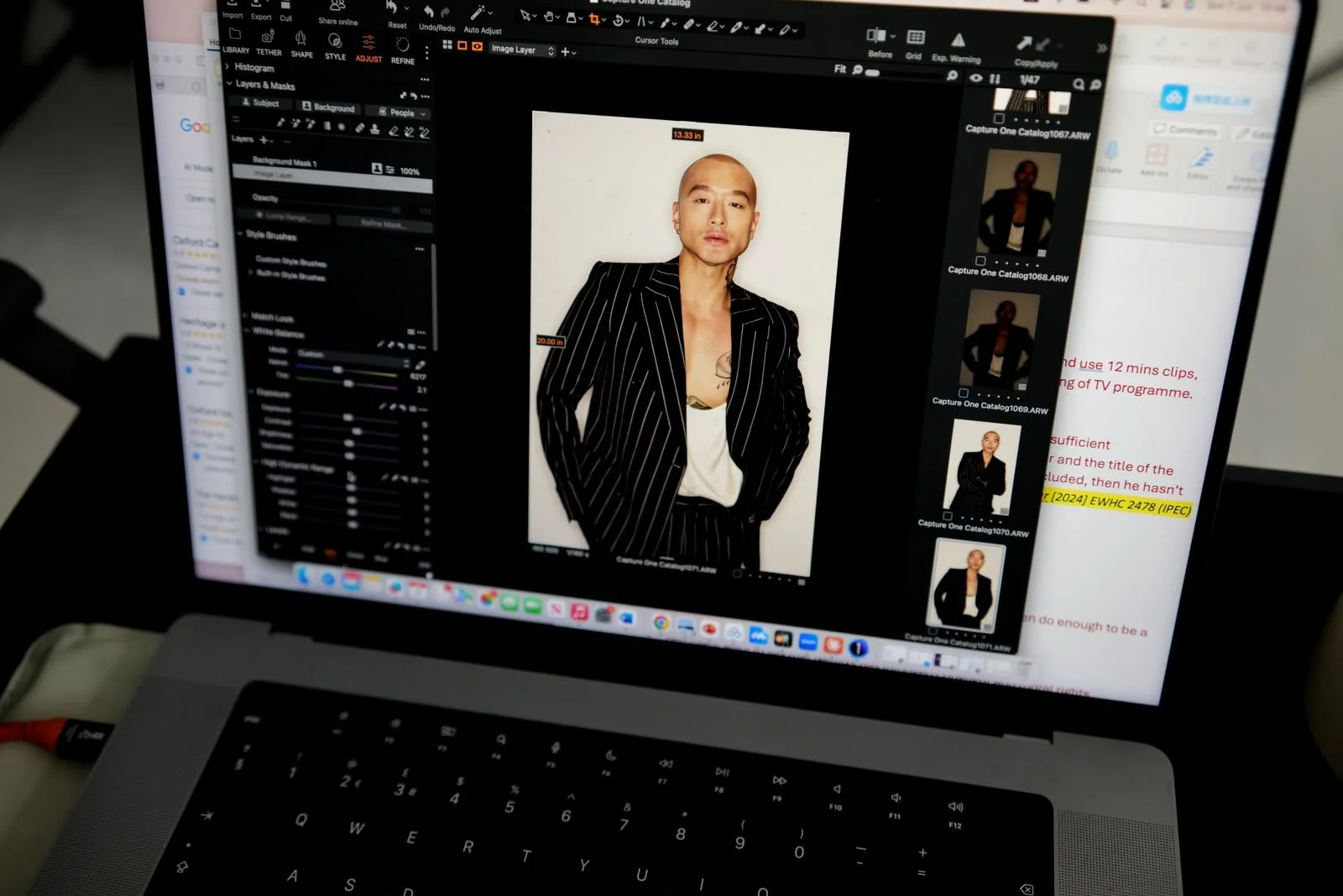Photograph of a laptop screen displaying a photo editing software with an image of a man in a black pinstripe suit and white shirt, standing against a white background. The software interface shows editing tools and multiple thumbnail images of the same person on the right side.
