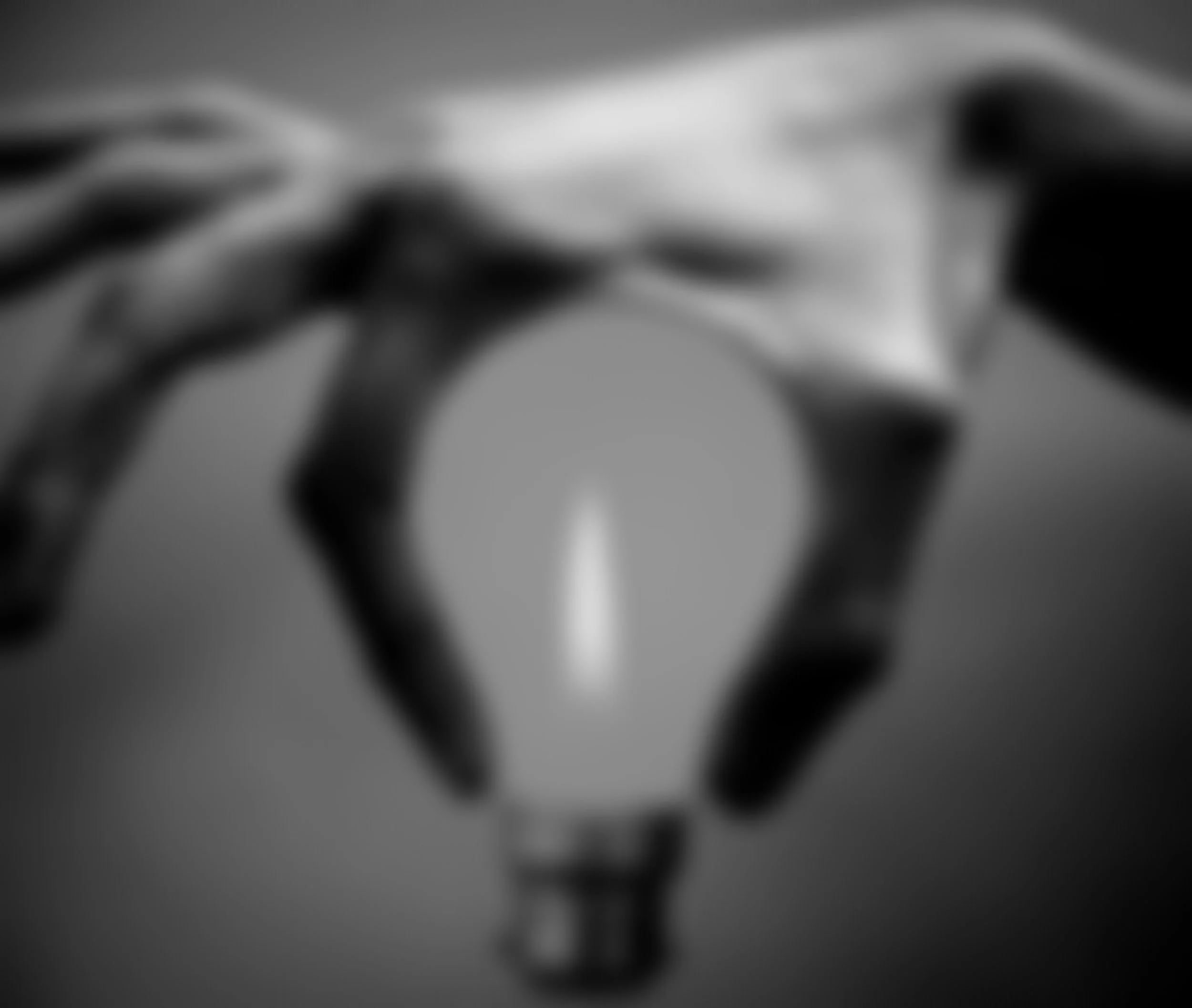 fingers around a lightbulb
