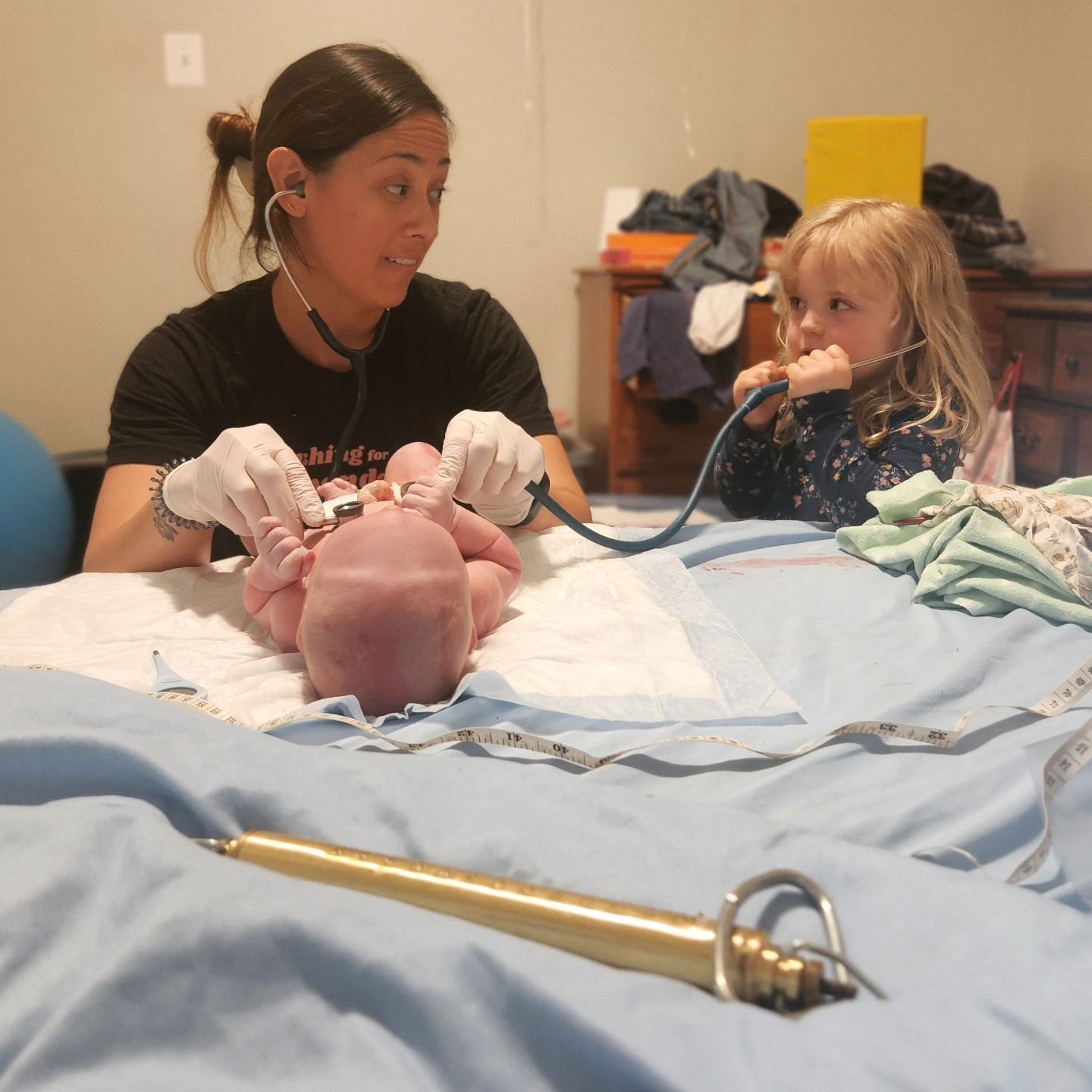 This is what family-centered postpartum care looks like. Big sister is involved as much (or as little) as she wants, as we check out her newborn brother head-to-toe. Turns out this midwife helper draws the line at bowel sounds- yuck! Isn't she the cu