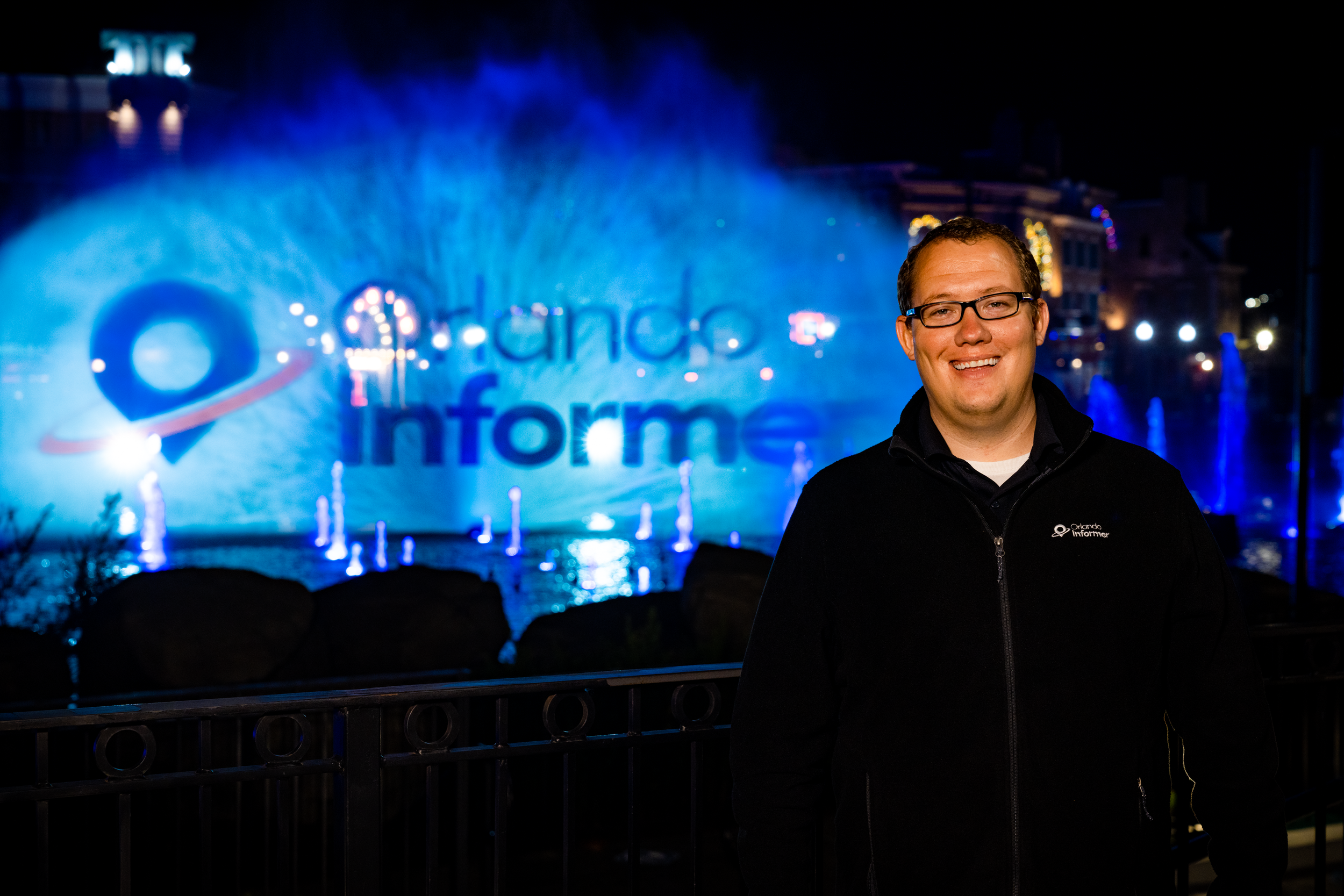 Matthew Miller, America's Theme Park Technologist, posing in front of the Orlando Informer water projection logo