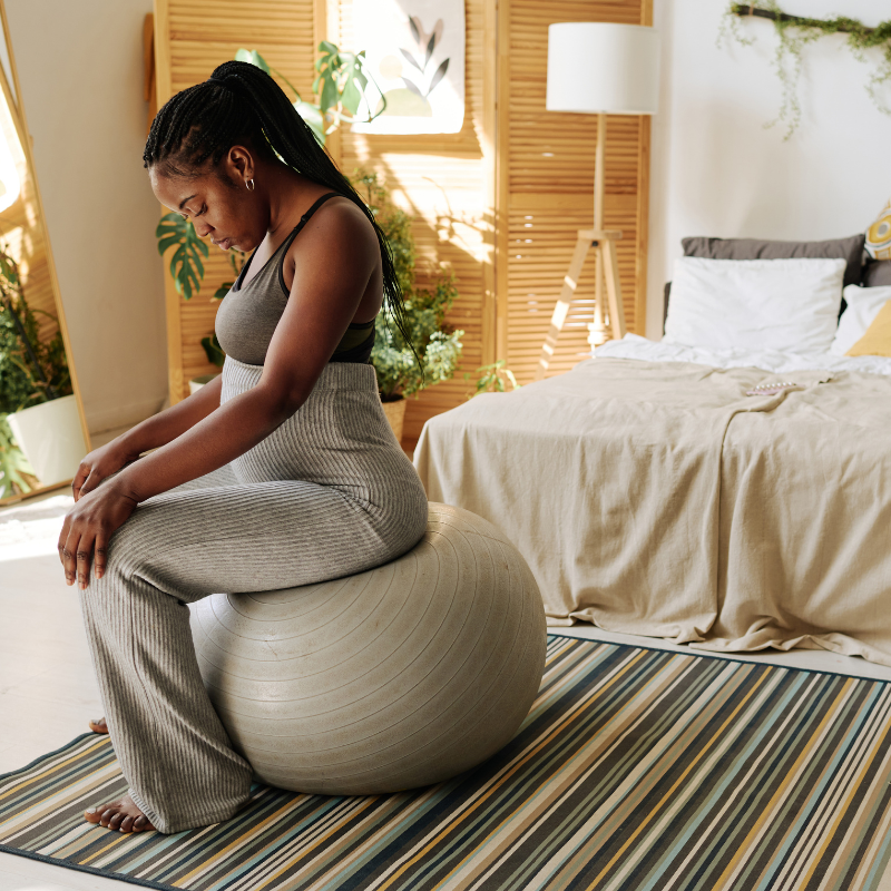 An outdoor shot of a Lakewood, Ohio street sign with a "Birth Map" guidebook resting against a park bench