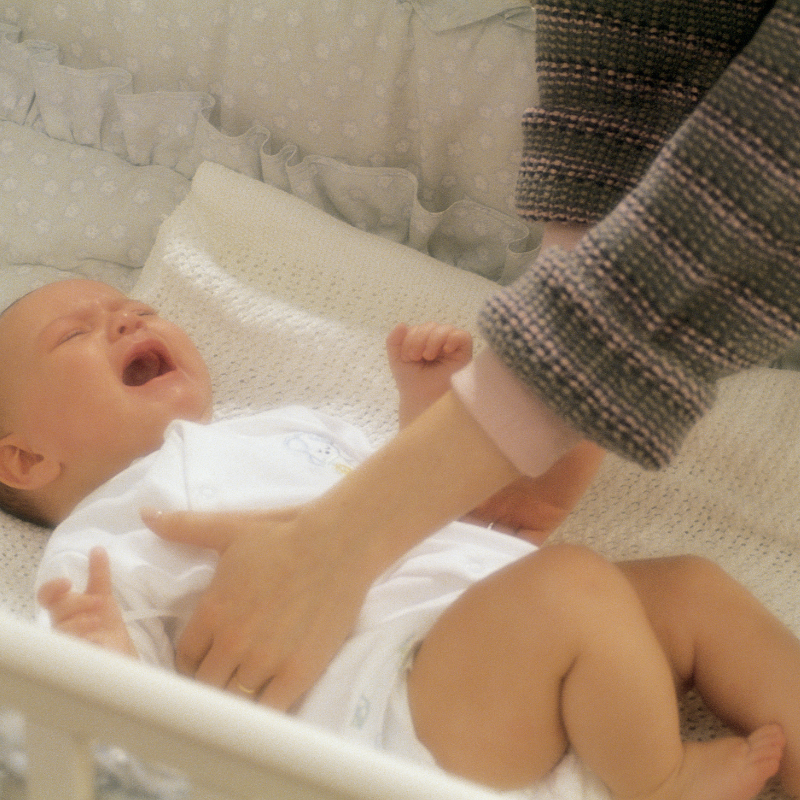 A Cleveland overnight doula from Nurtured Foundation providing hands-on soothing for a baby during the 4-month sleep regression.