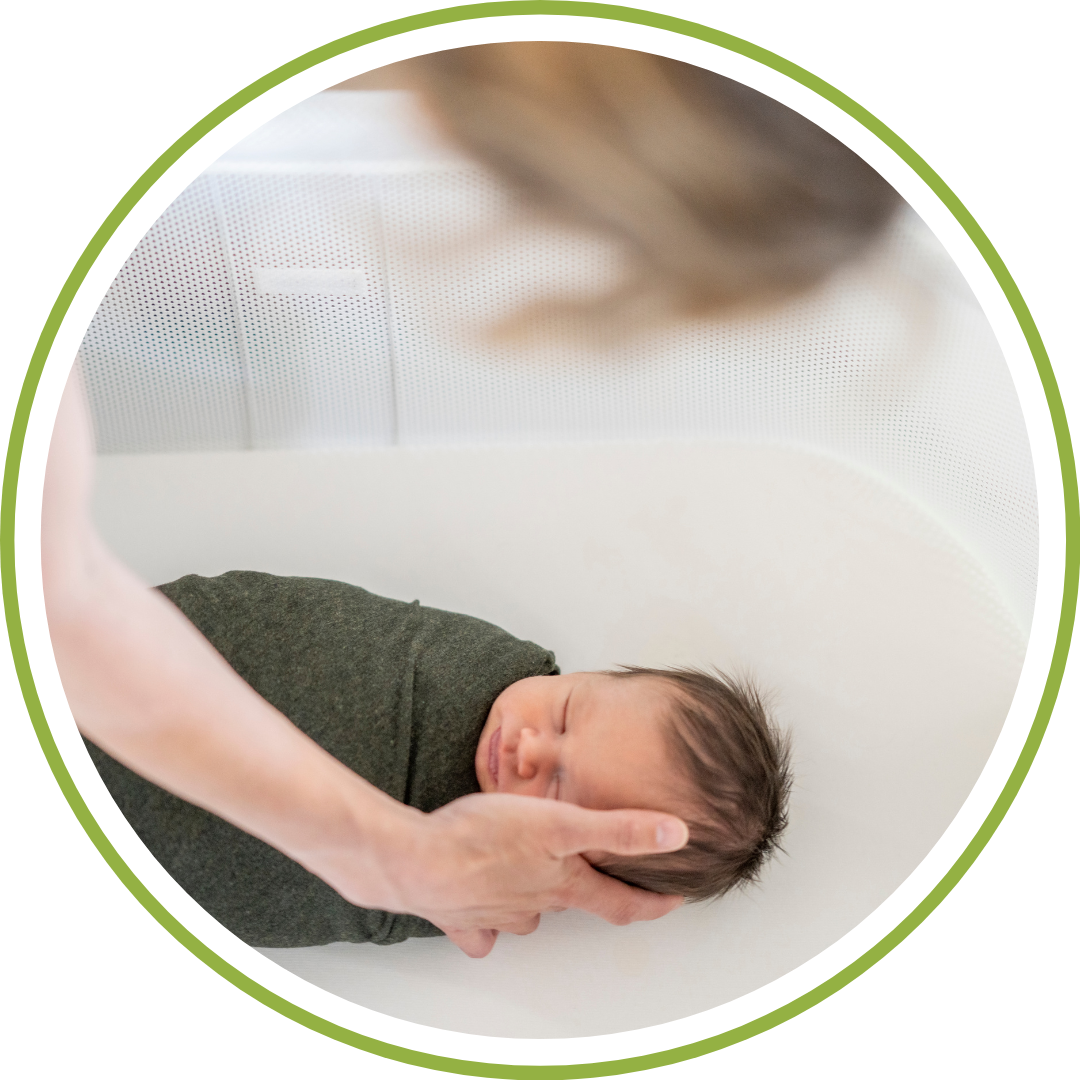 parent gently leaning over a crib in a dimly lit nursery, pausing to observe their moving newborn before deciding to pick them up.
