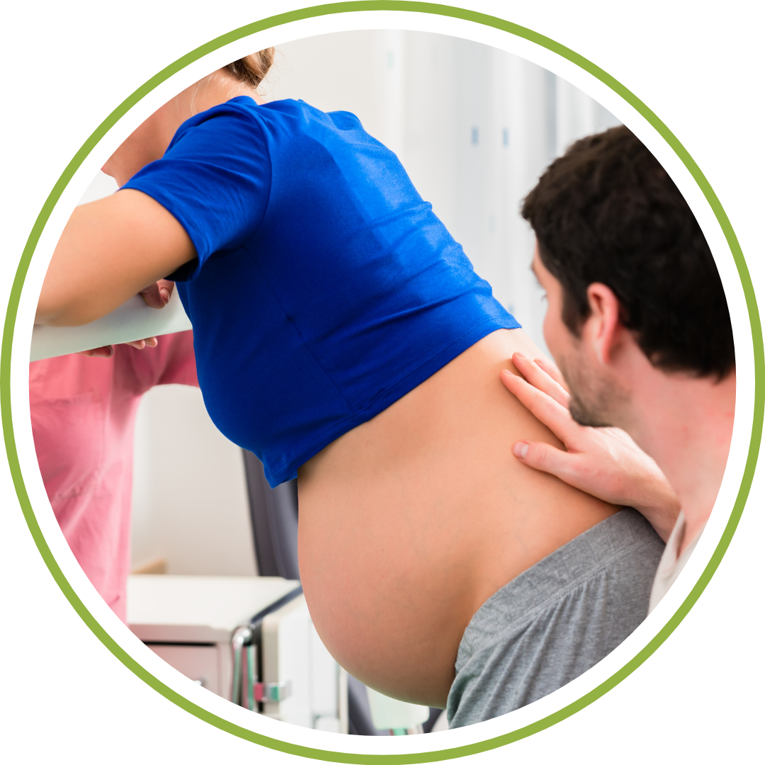 A partner supporting a pregnant woman using counter pressure comfort measures during a private childbirth education class