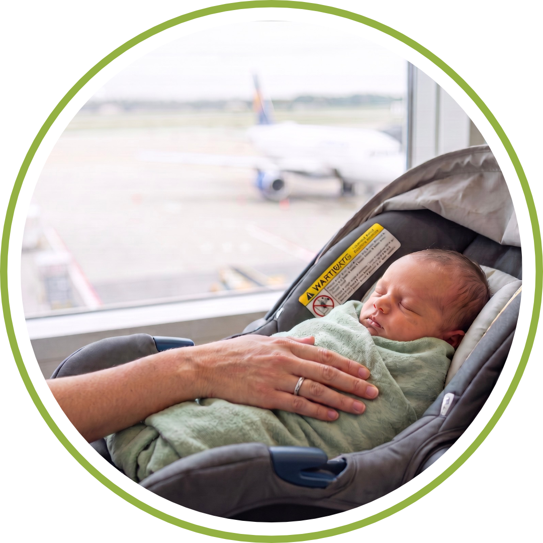 Sleeping newborn in an infant car seat at an airport gate, waiting to fly home after a surrogacy birth