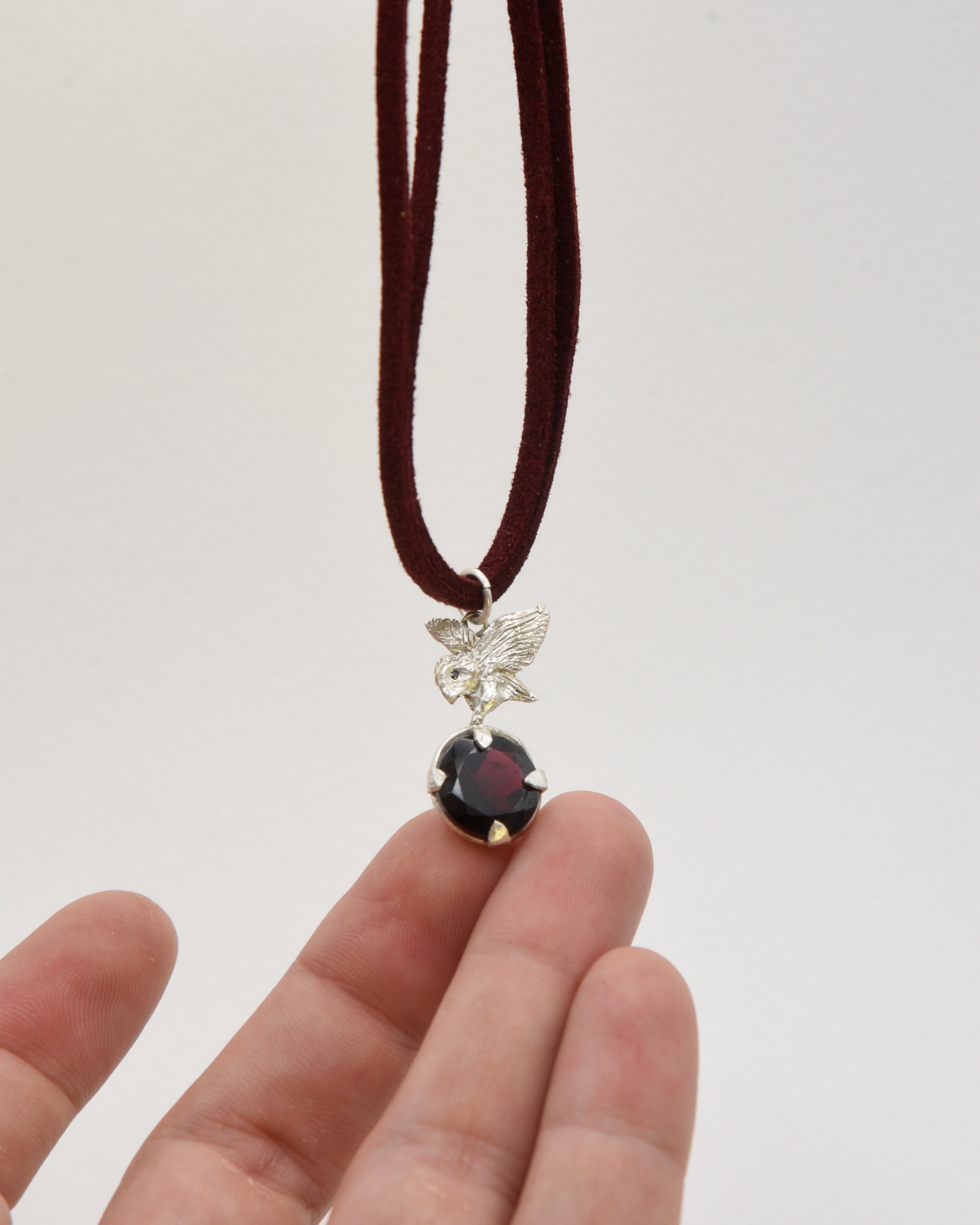 Owl Holding A Garnet Necklace