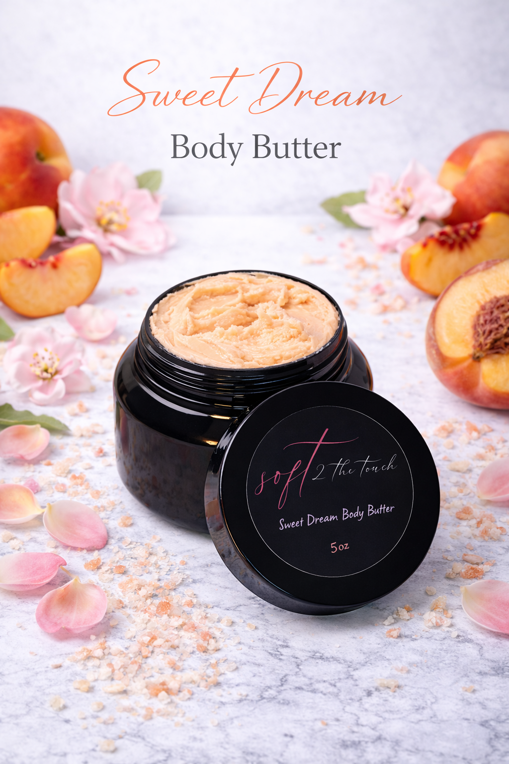 Open jar of Sweet Dream Body Butter on marble surface, surrounded by peach slices, pink flower petals, and peach blossoms, with a soft purple background.