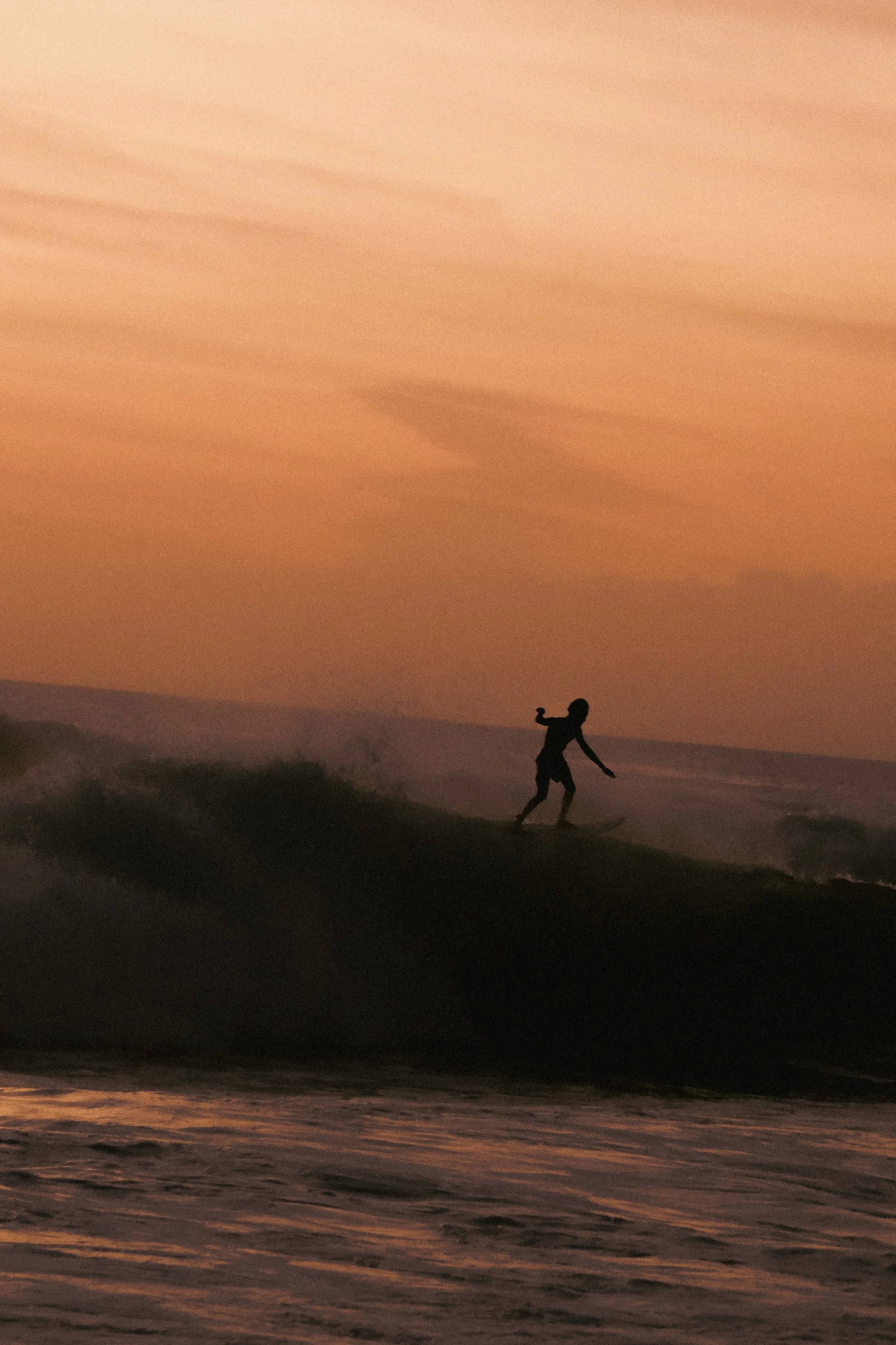 "Sunset Ride"
A lone surfer riding beneath the burning skies of Bali, Indonesia.