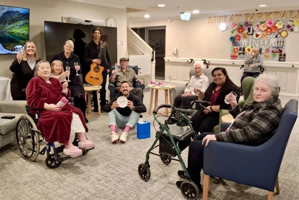 Jimmy Leishman with a group of residents of an aged care facility.