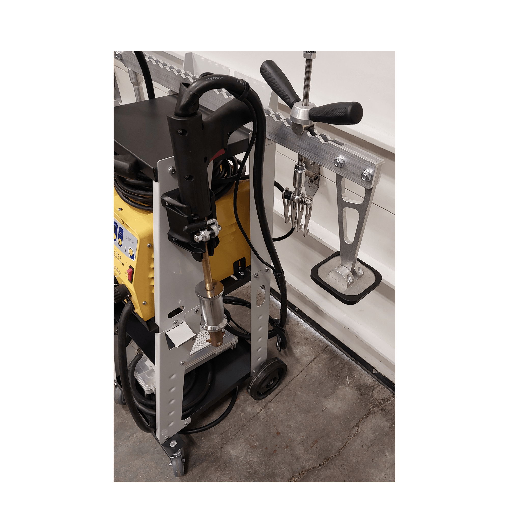 Used GYS dent pulling bridge with accessory kit for automotive body repair.