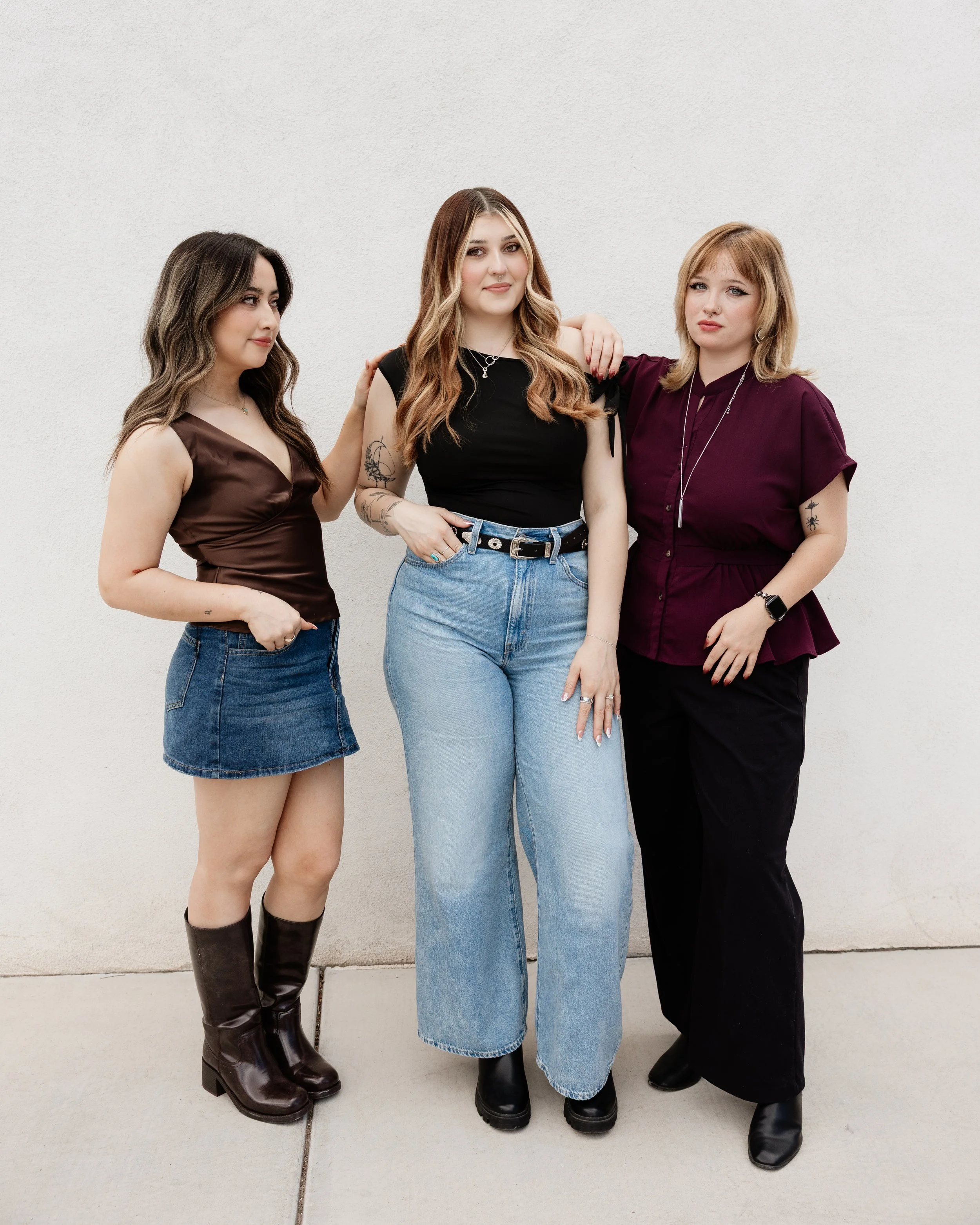 hairstylists standing next to each other in front of a white wall sister hair studio new mexico