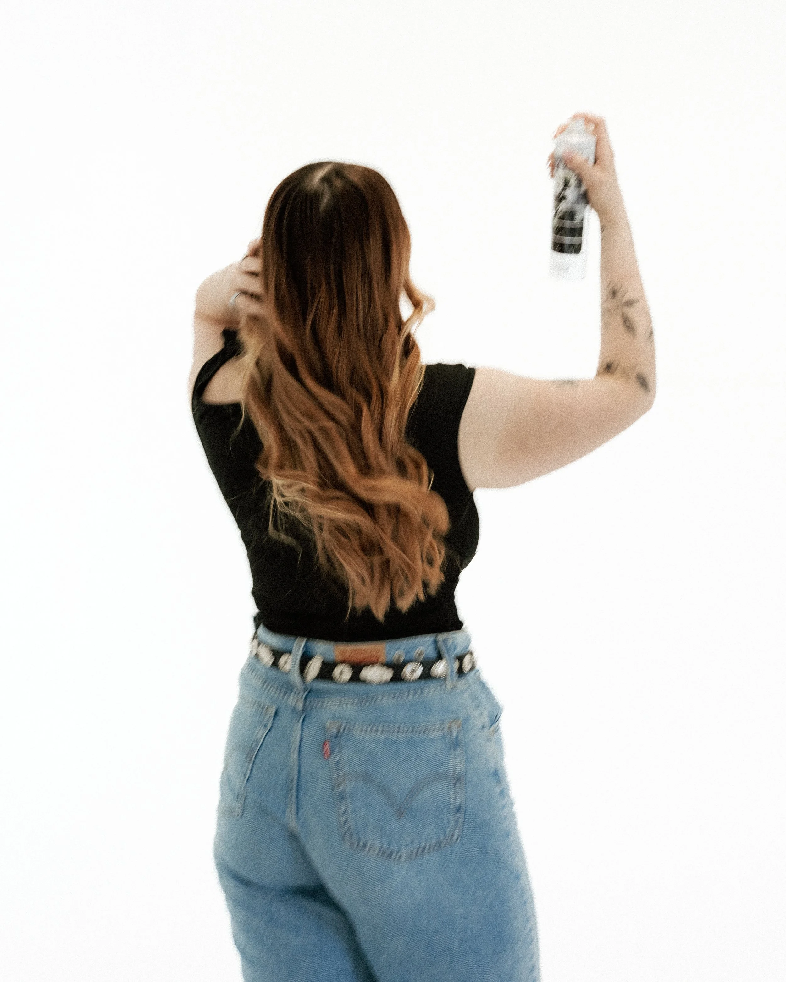 hairstylist applying hairspray sister hair studio new mexico