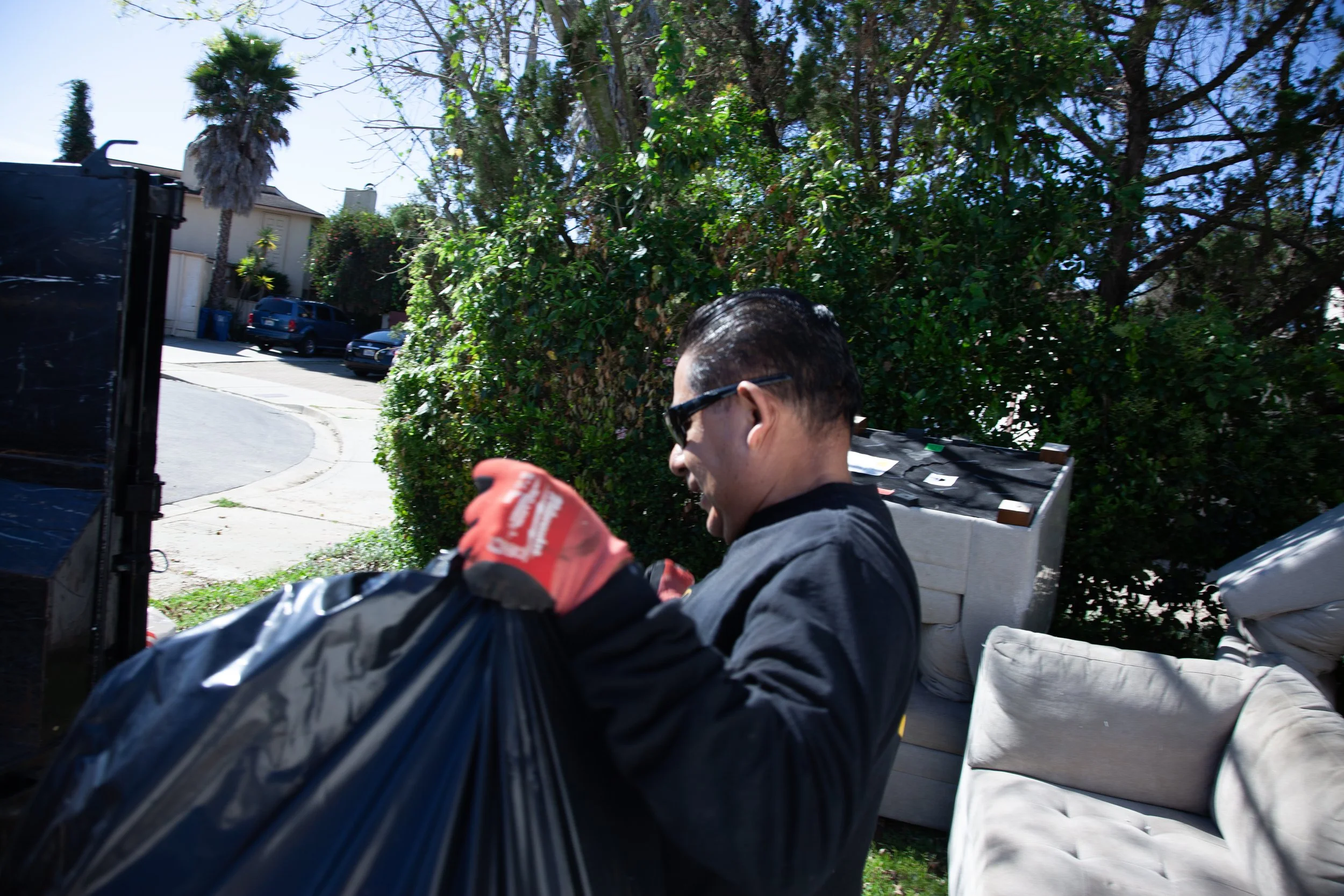 Trash being thrown onto our trailer for dumping.
