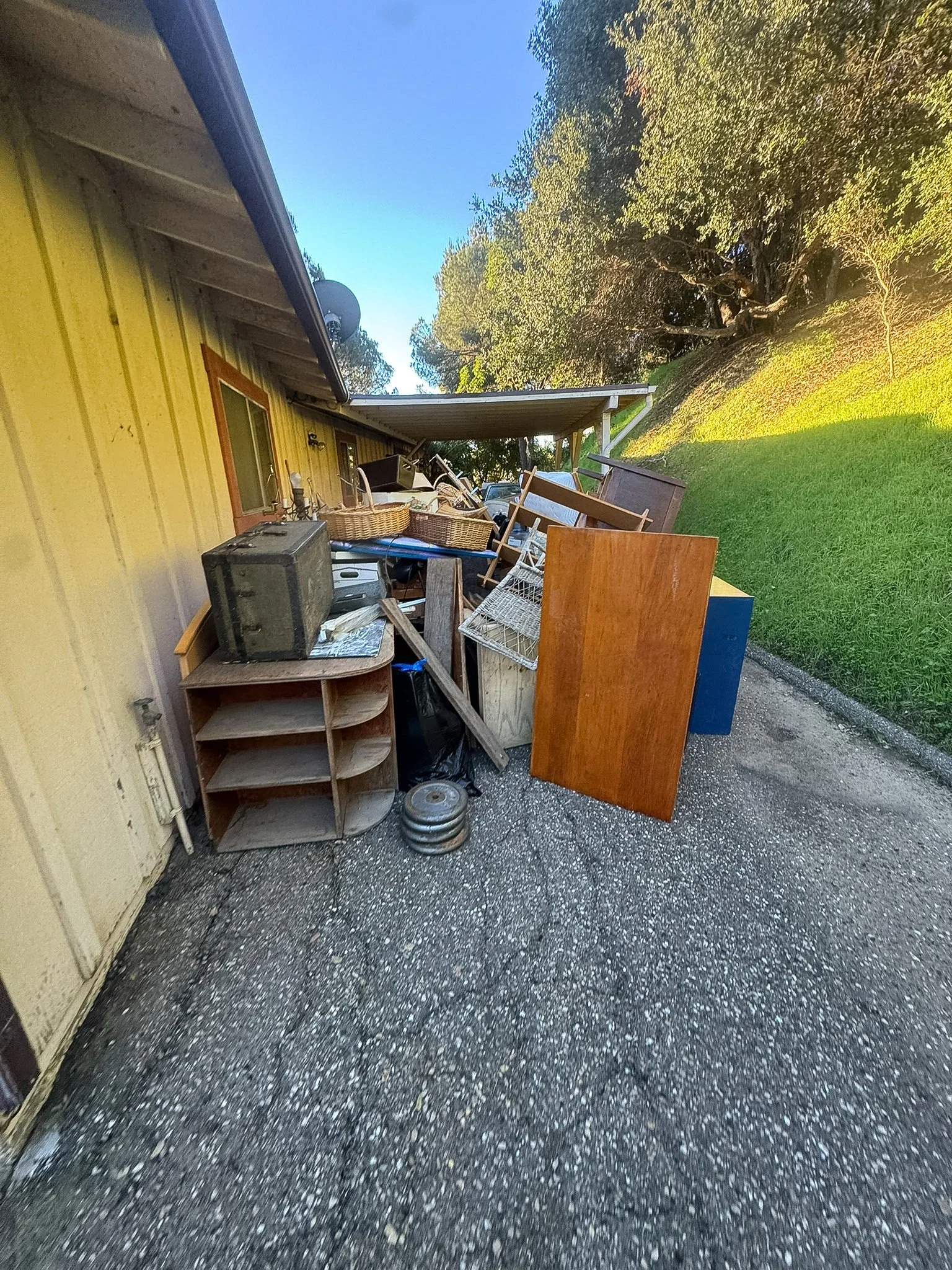 Before junk removal: Old furniture, shelving, and household clutter ready for pickup by Hauling-4-U. Serving Santa Barbara and Ventura, with furniture removal and property cleanout services.
