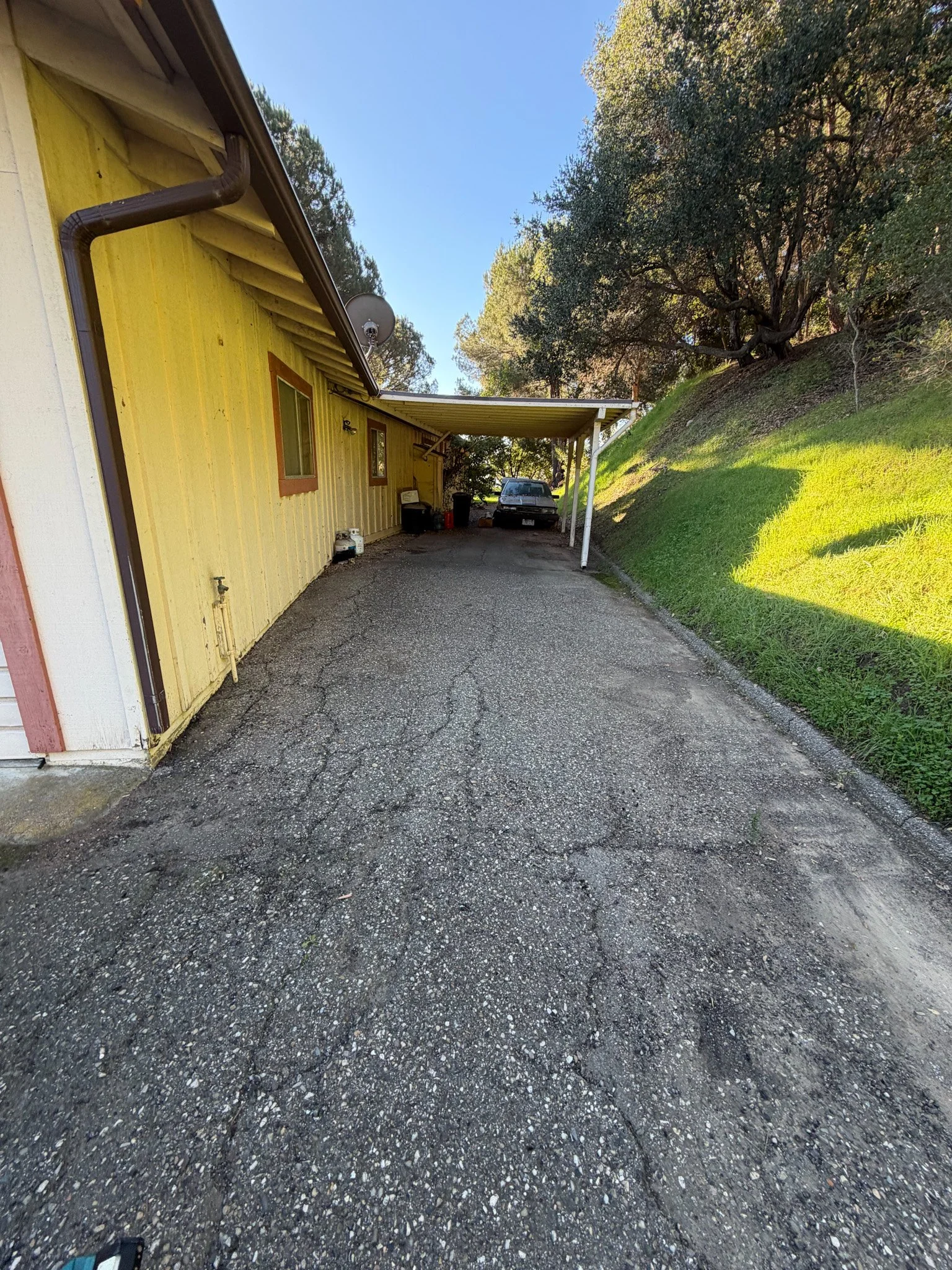 After junk removal: Driveway cleared of old furniture, shelving, and household clutter by Hauling-4-U, restoring usable space. Serving Santa Barbara and Ventura Counties with junk removal and property cleanout services.