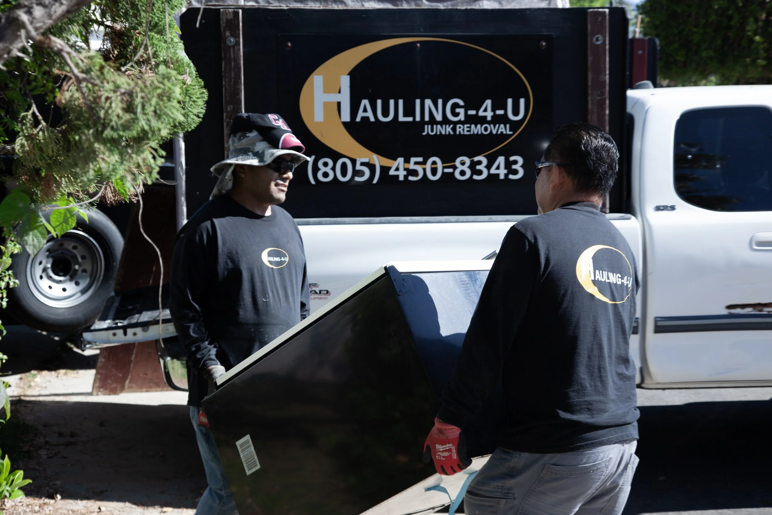 Our team carrying out an old refrigerator.