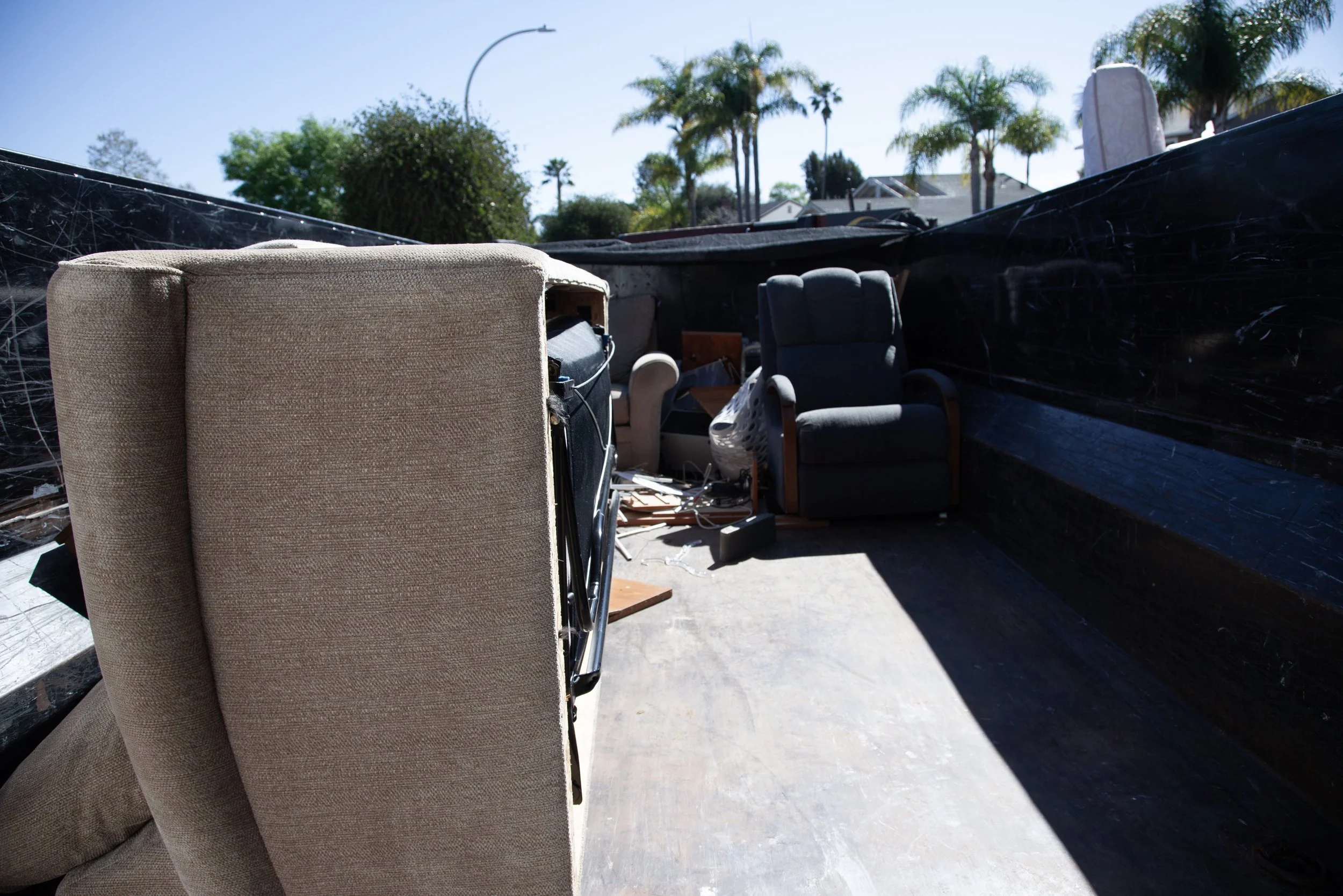 Couch and home items being hauled out of a clients front yard