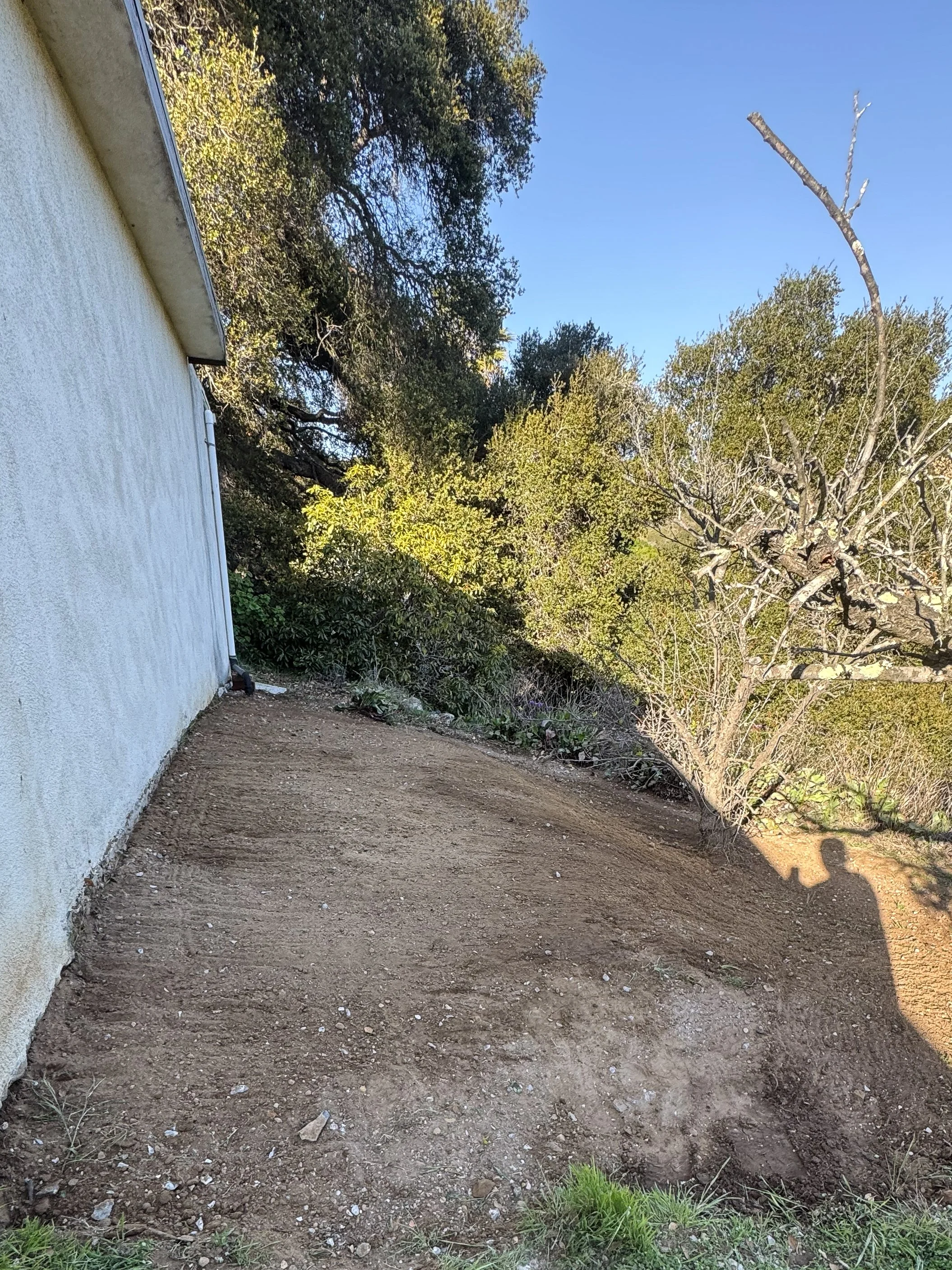 An empty cleared backyard where all the concrete debris has been removed.