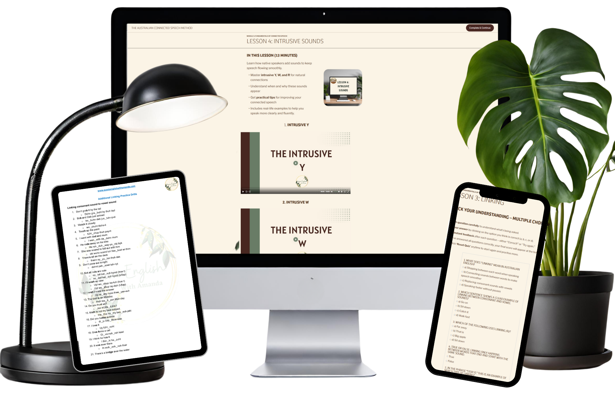 Desk setup with a computer monitor, tablet, and smartphone, displaying language learning content on speech sounds and linking consonants, with a green plant in a black pot and a black desk lamp.