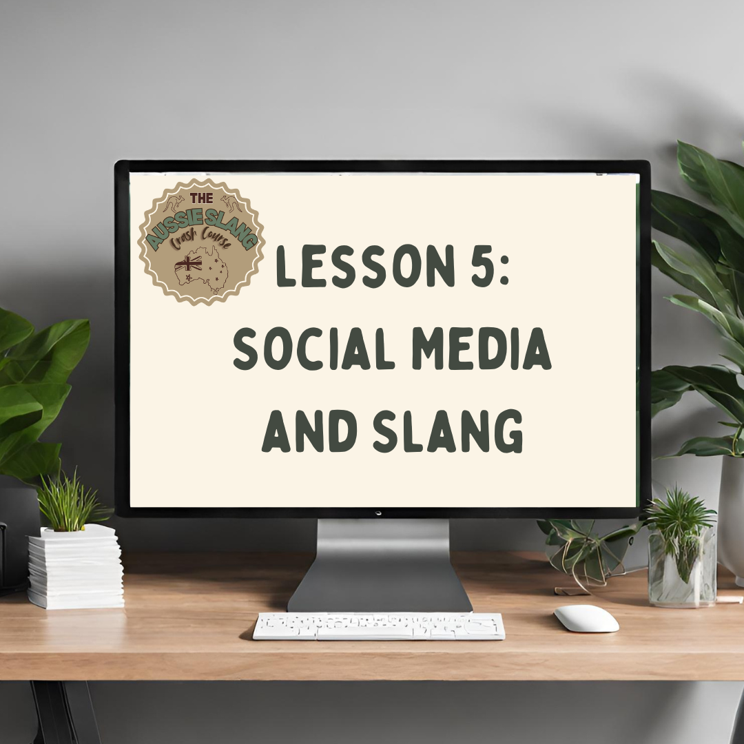 Computer monitor on wooden desk displaying a lesson titled "Lesson 5: Social Media and Slang" with plants on either side.