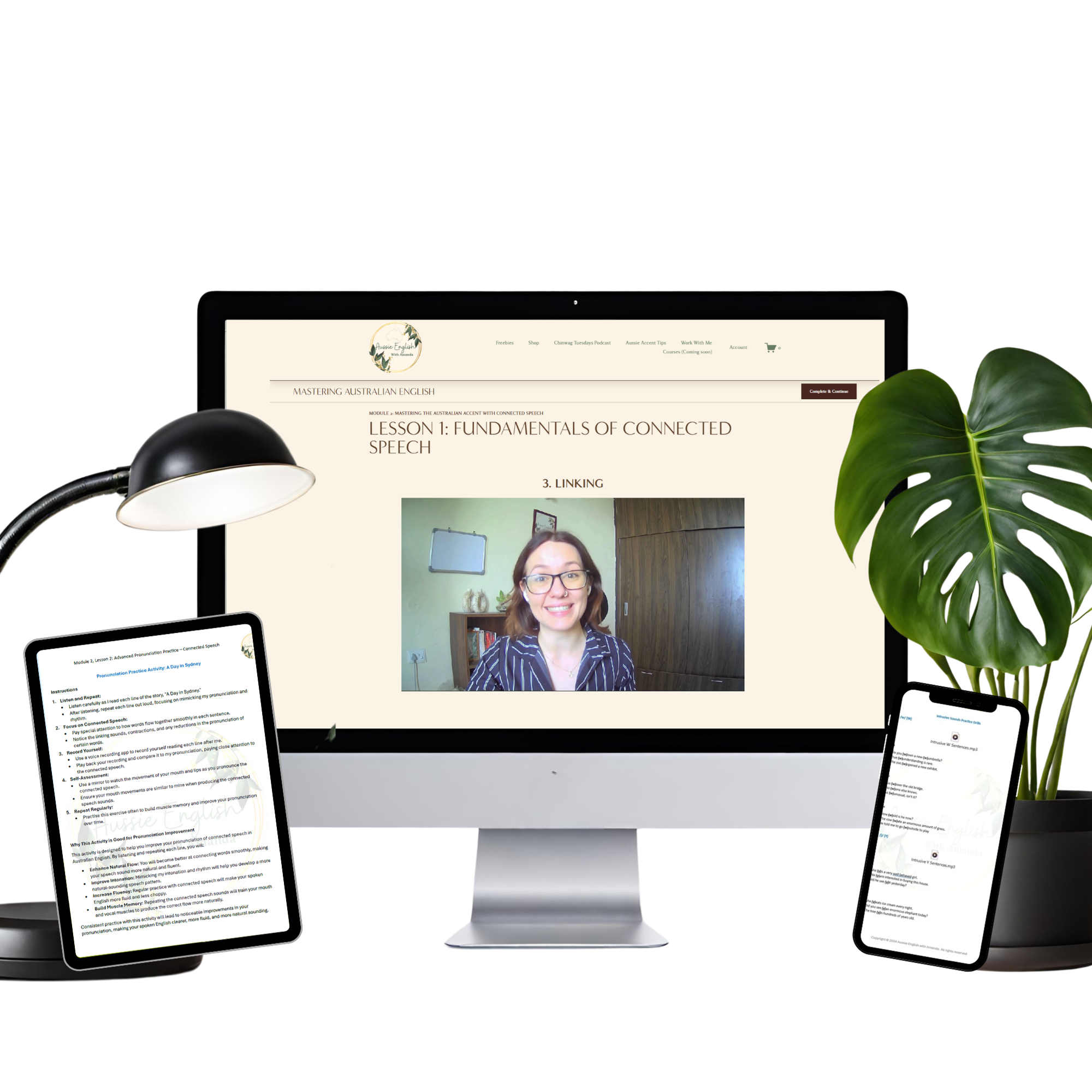 Computer monitor displaying an online lesson on connected speech, with a smiling woman visible on the screen, flanked by a desk lamp, a tablet, a smartphone, and a large potted Monstera plant on a desk.