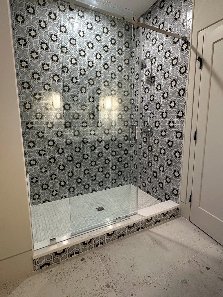 Floor-to-ceiling guest bathroom wall tiles featuring a geometric star motif inspired by Eastern design.